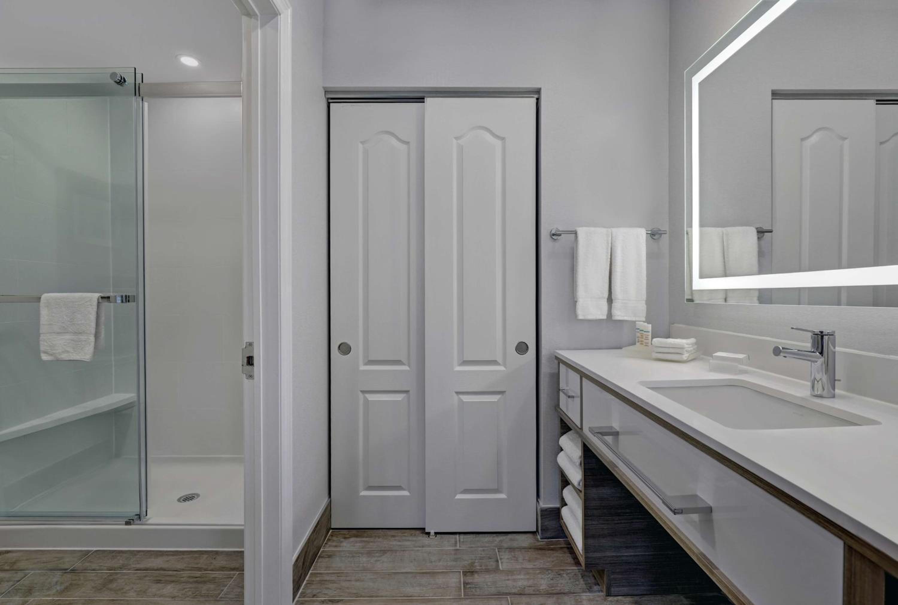 bathroom with two sinks and a walk - in shower