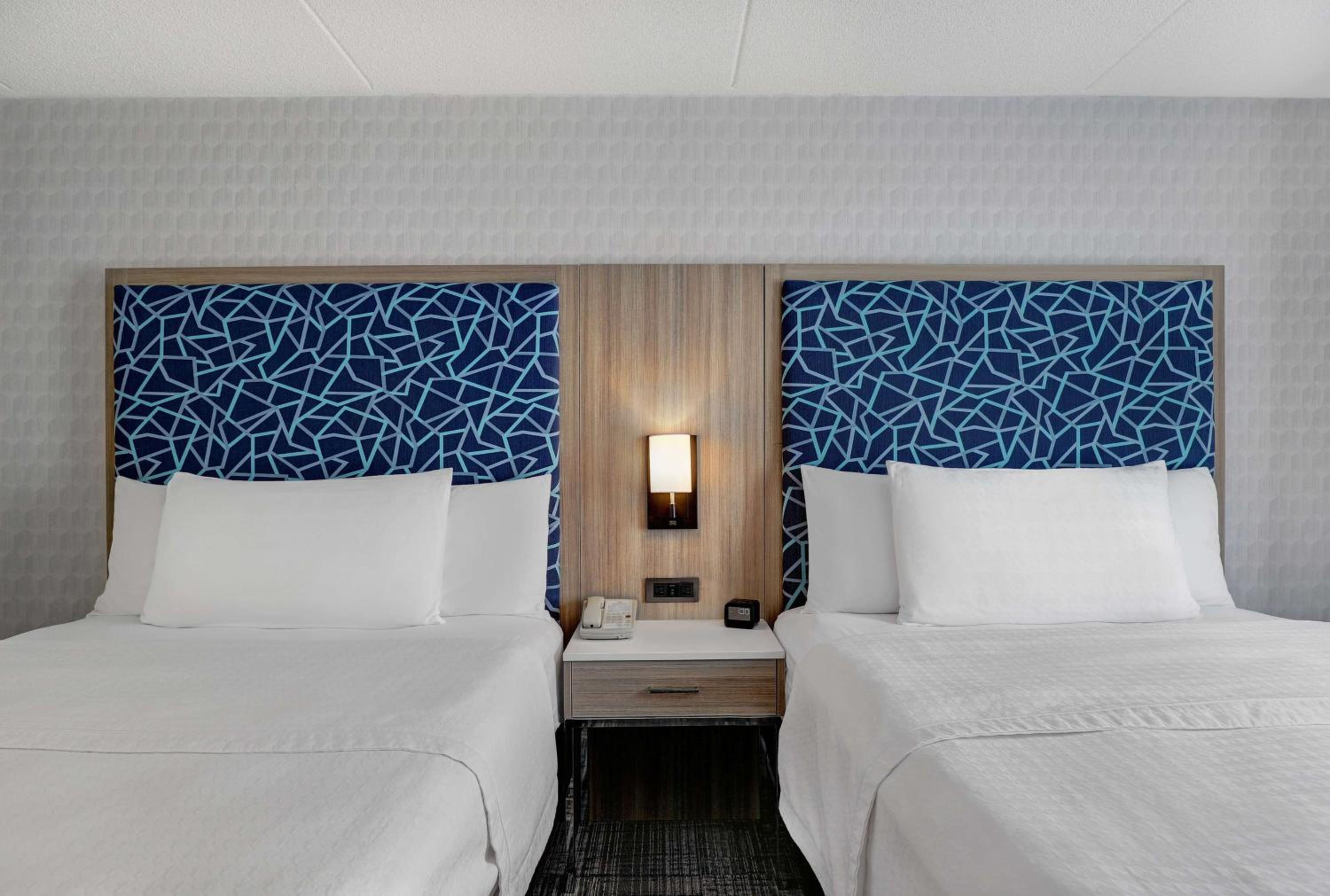 hotel room with two twin beds and a night stand