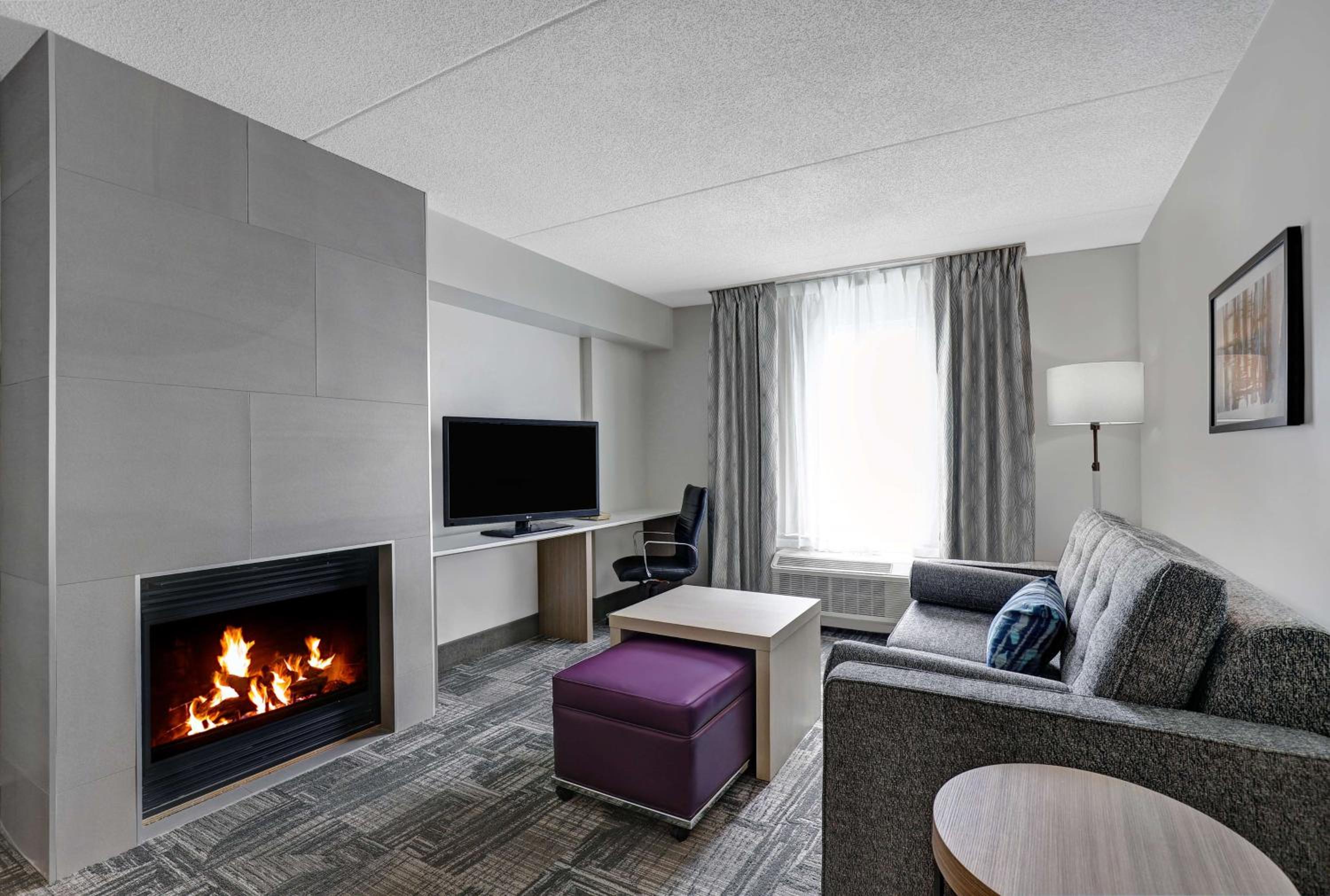 living room with a fireplace in the middle of it
