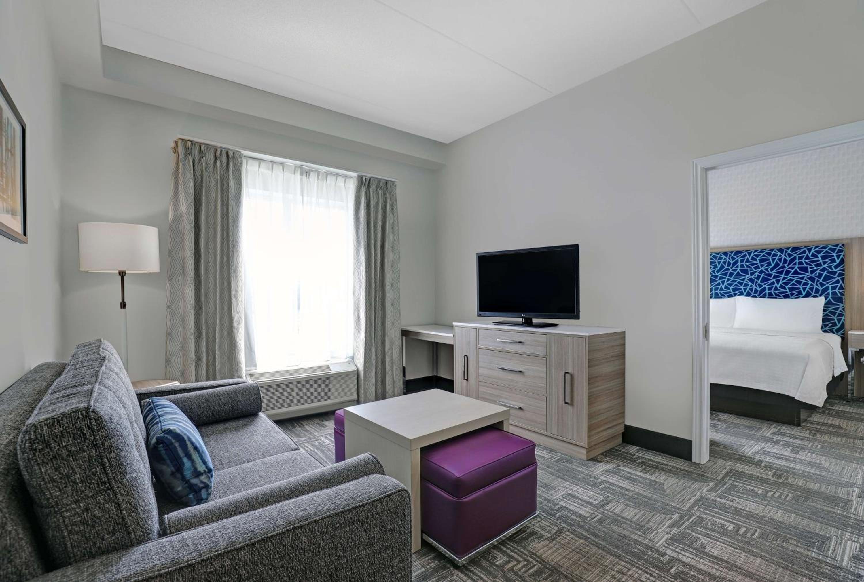living room with a couch, coffee table, and television