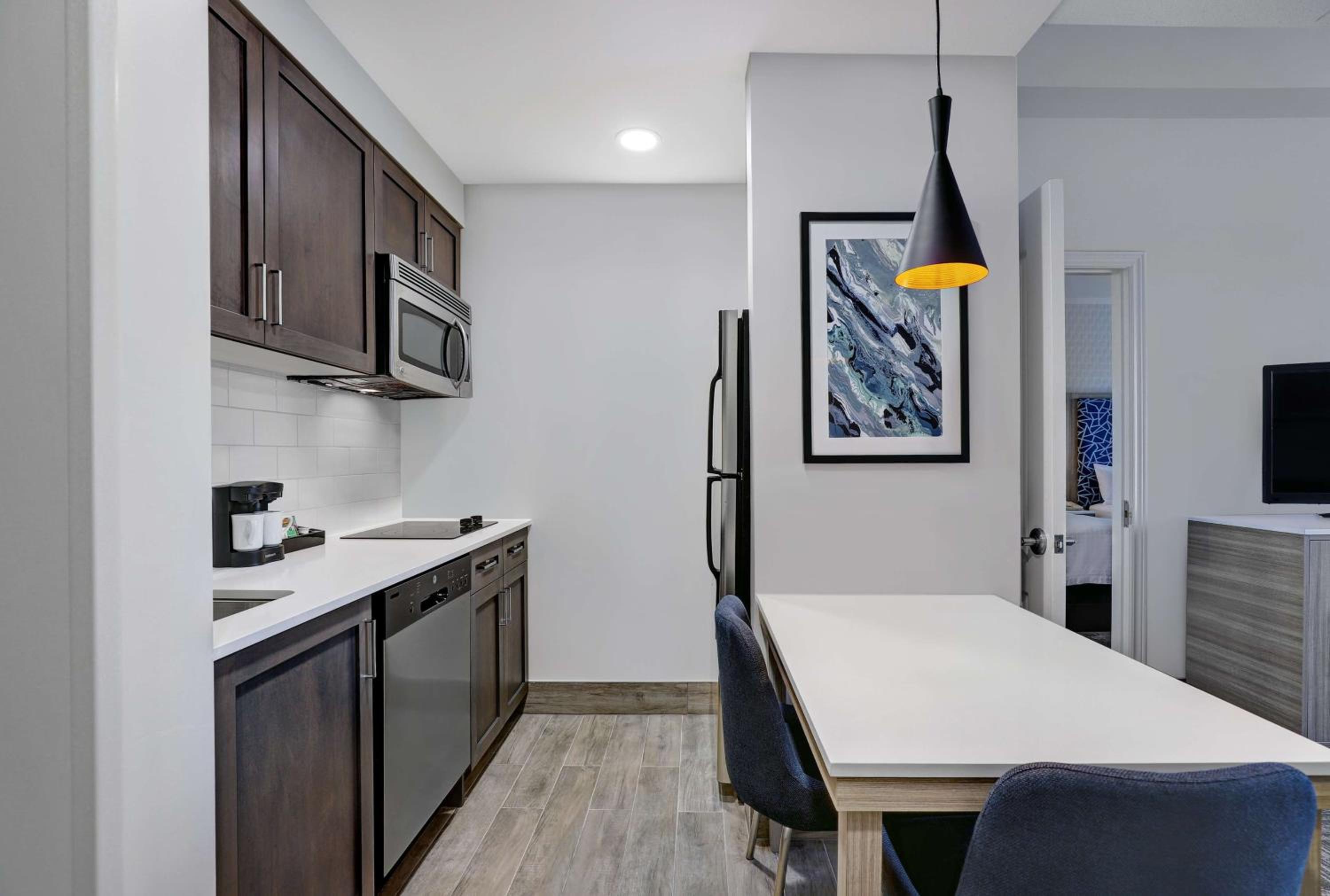 kitchen with white counter tops and dark wood cabinetry