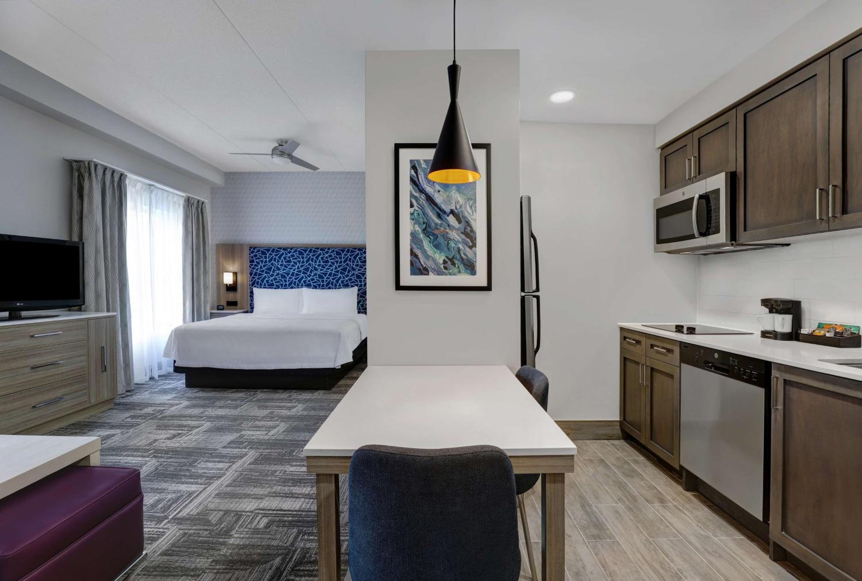 hotel room with a kitchen, living room, and bedroom