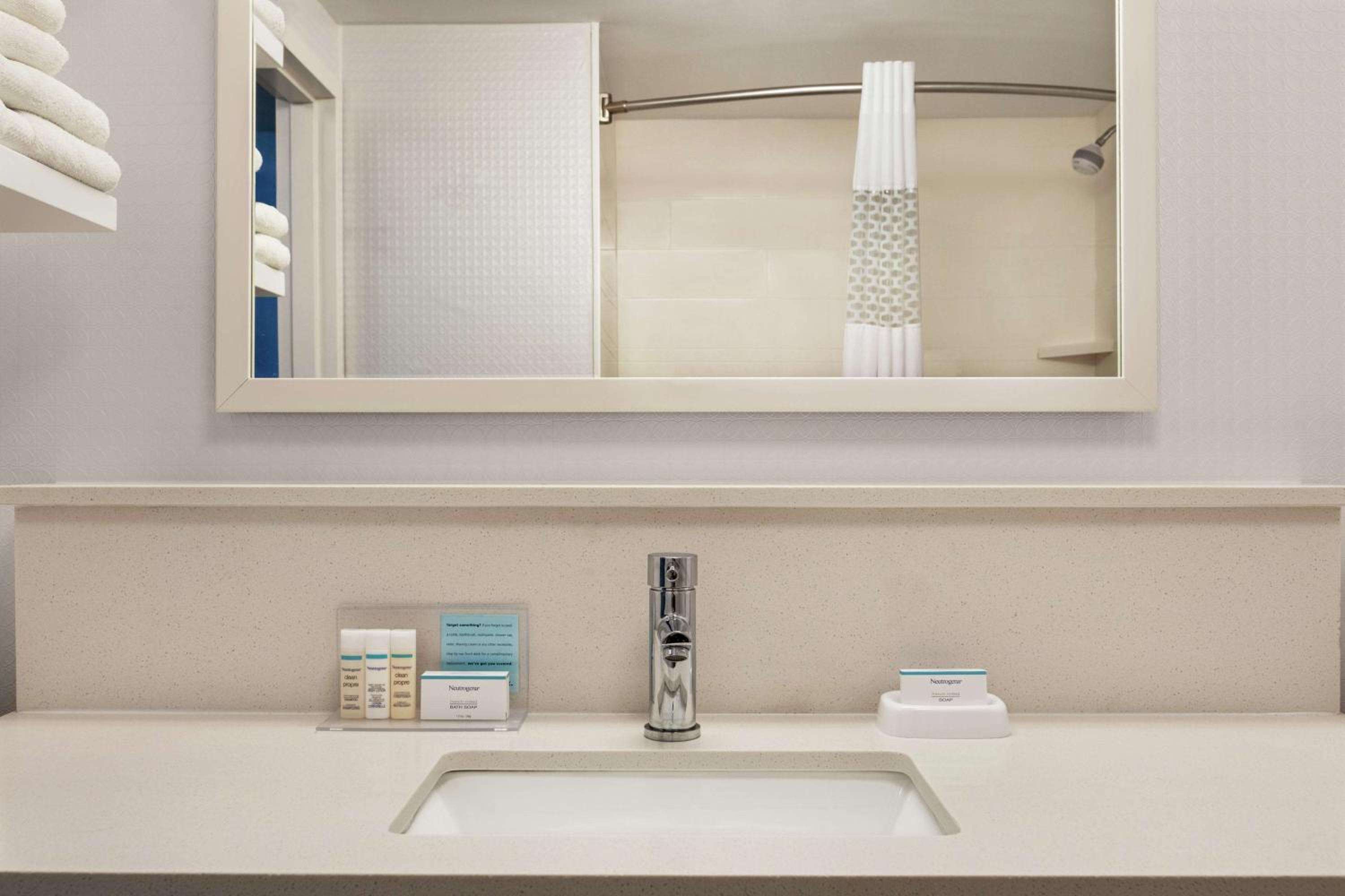 bathroom sink with a mirror and soap dispenser