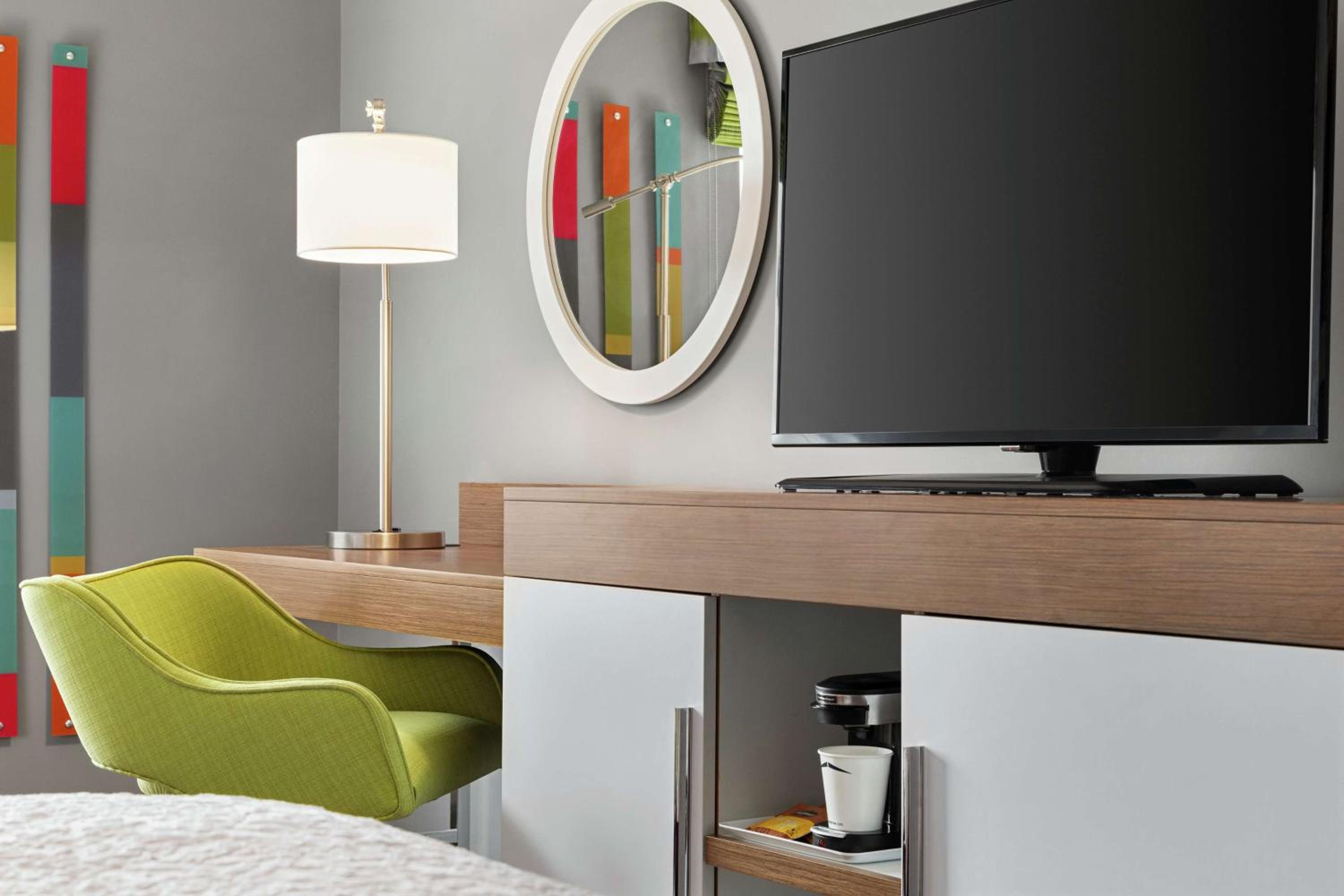 bright green chair in front of a flat screen tv