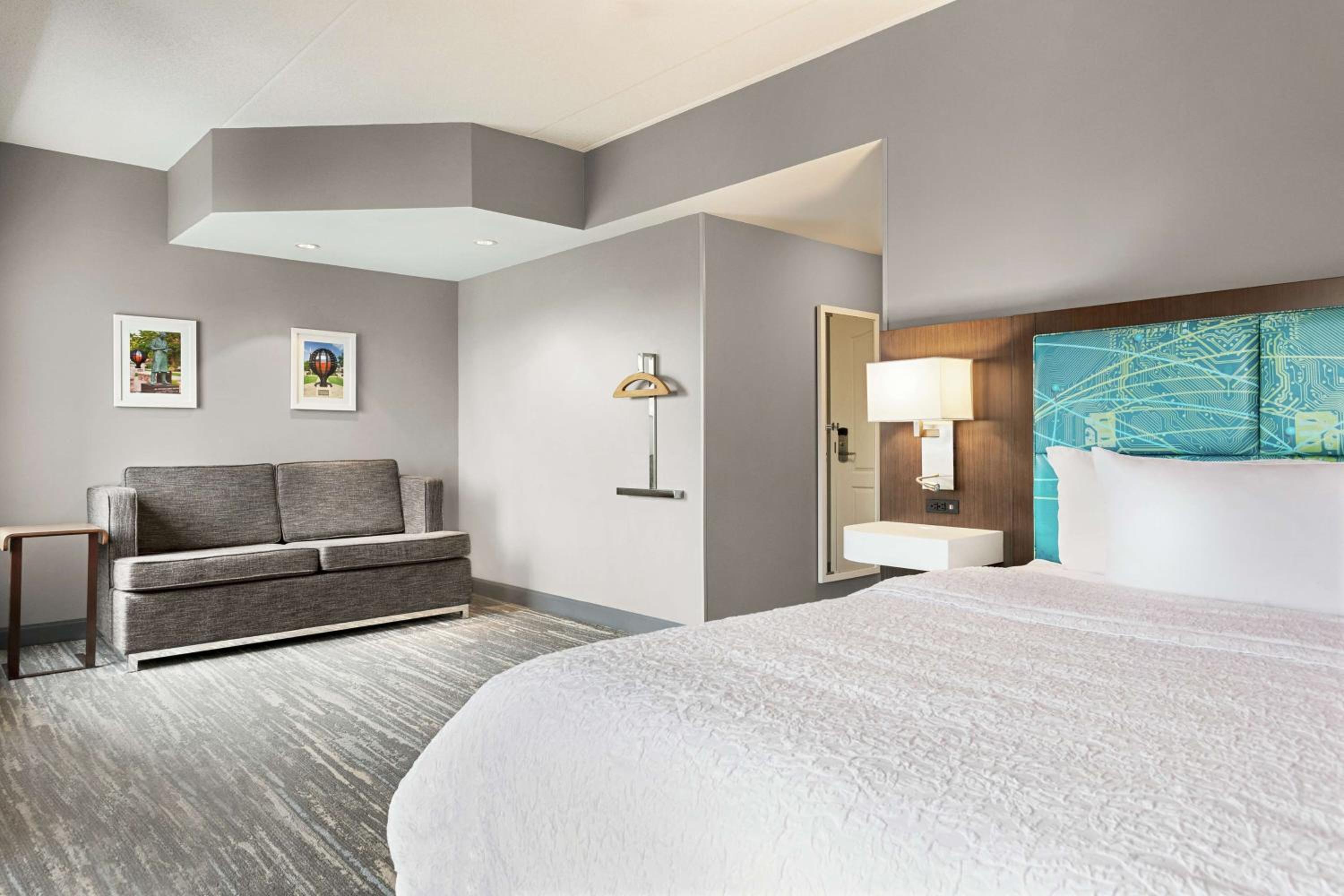 hotel room with a king size bed and a sofa