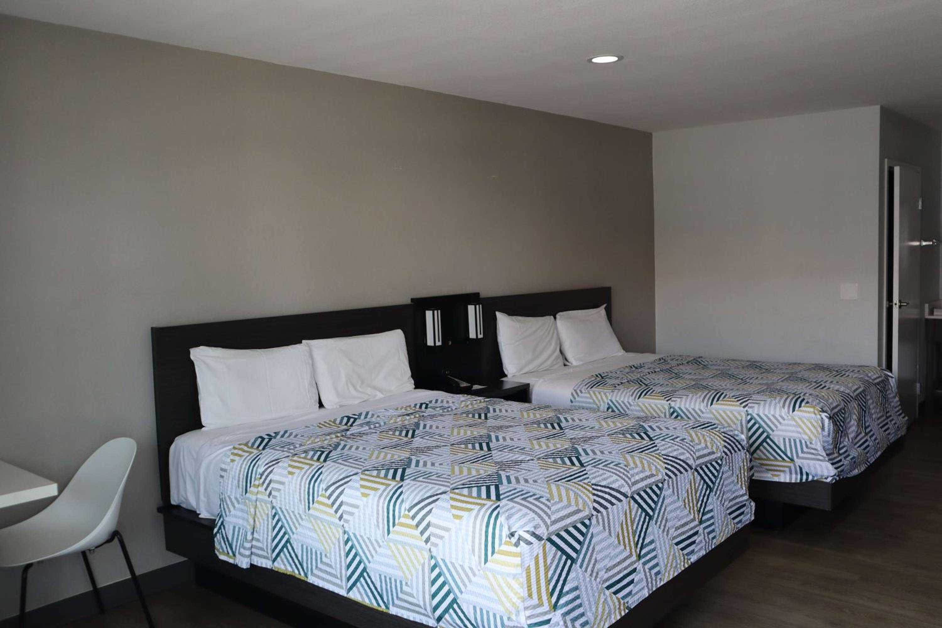 Deluxe Queen Room with Two Queen Beds - Smoking - Photo 1