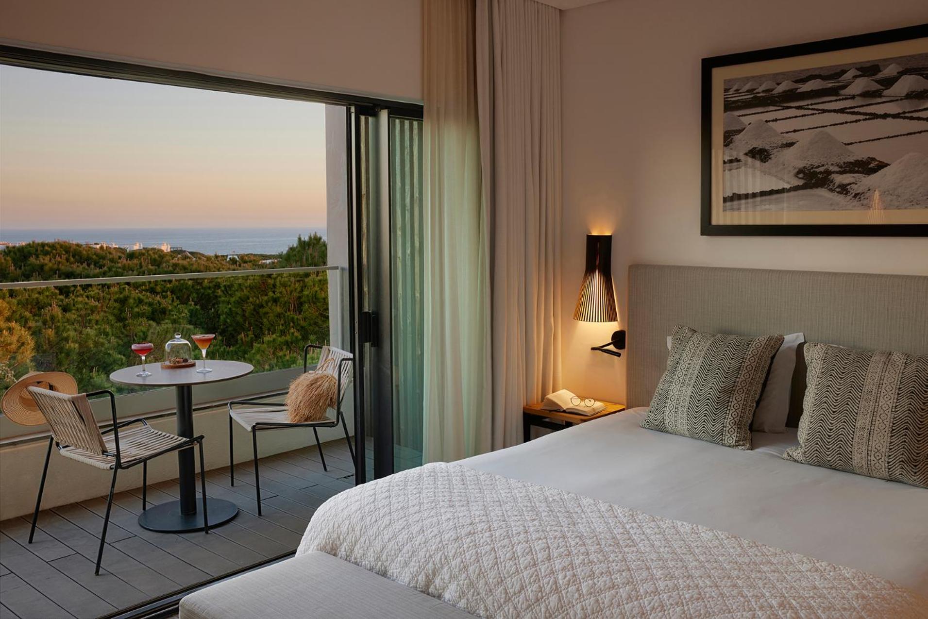 hotel room with a view of the ocean and mountains