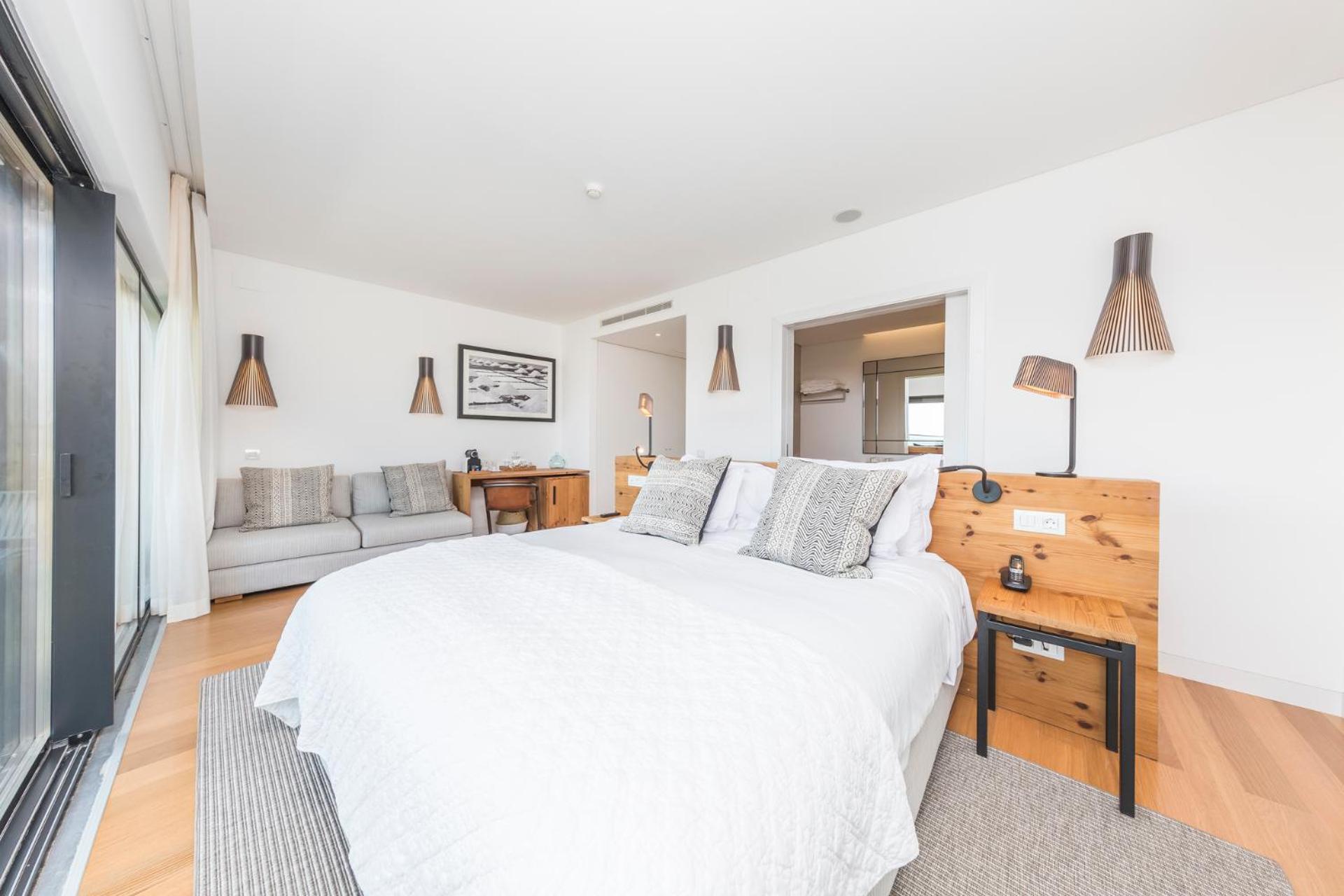 bedroom with a bed, couch, and sliding glass door