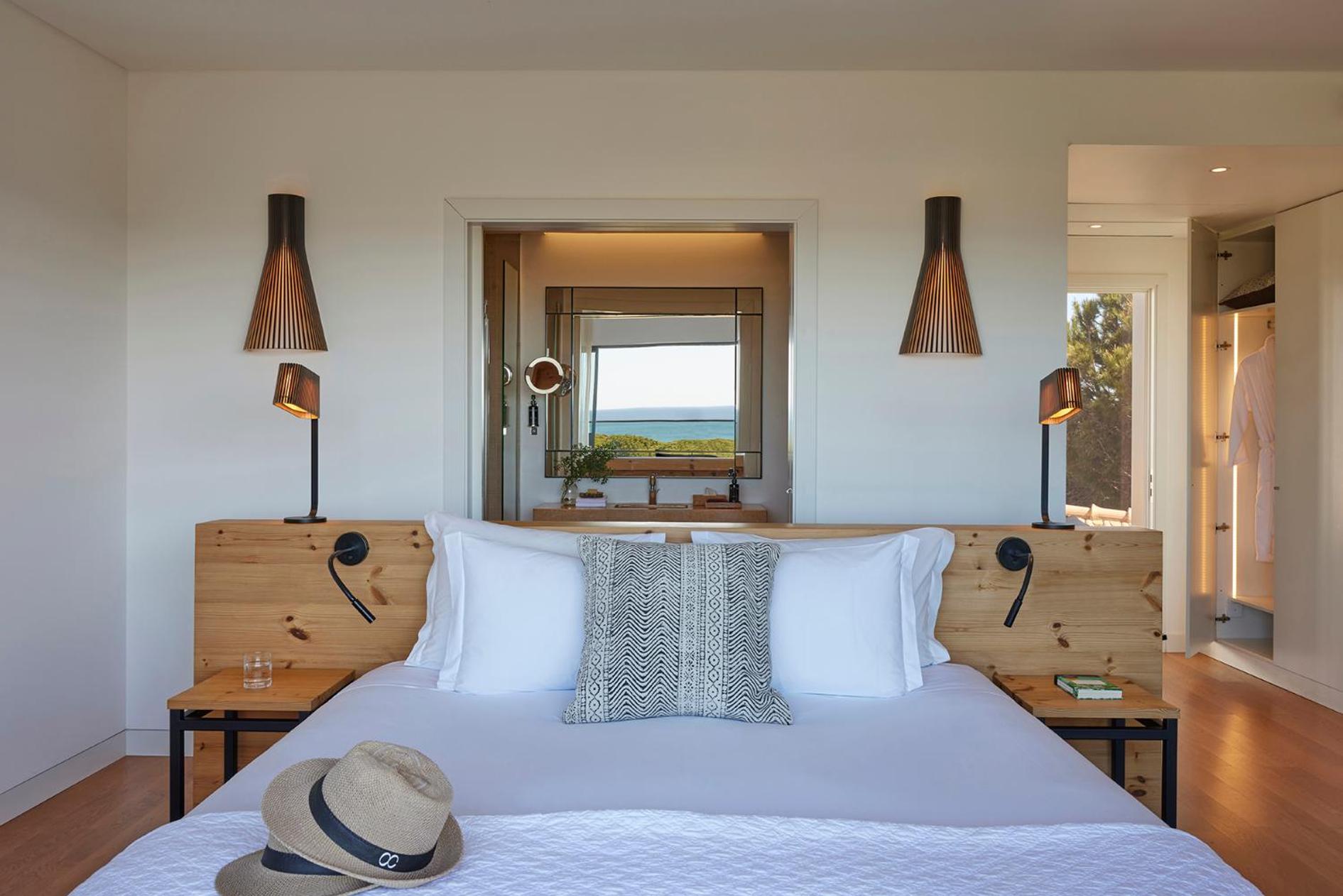 bedroom with a white bed and a hat on it