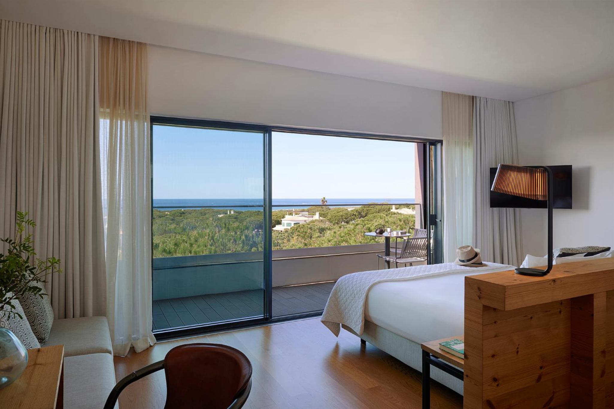 hotel room with two beds and a view of the ocean