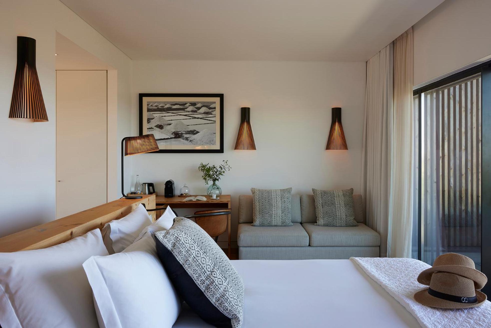 view of a bedroom with a couch and a bed
