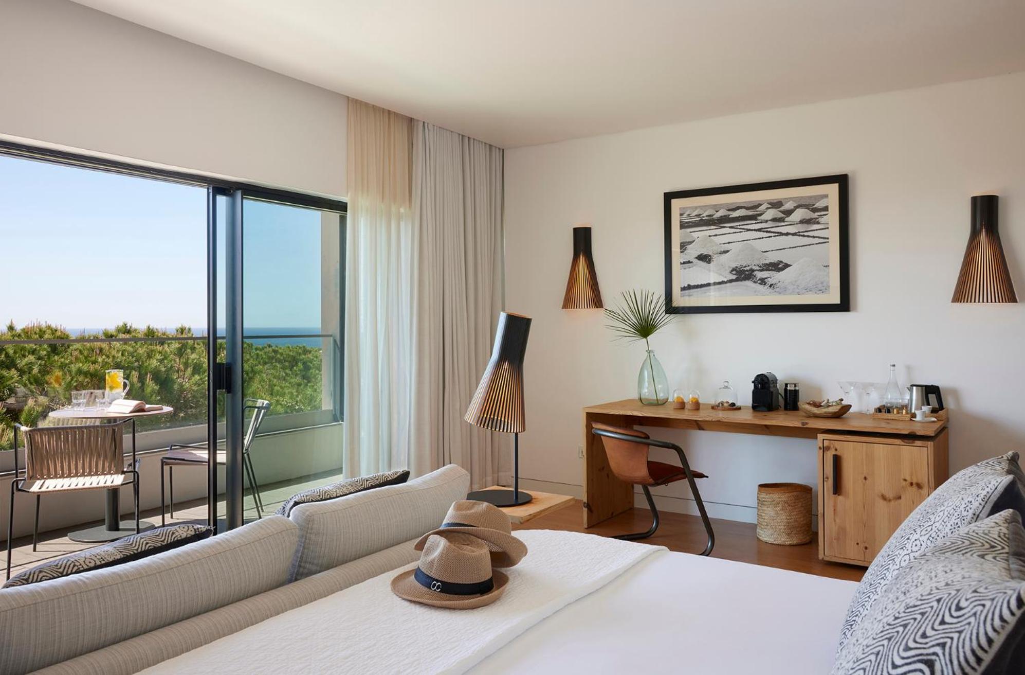 hotel room with a view of the ocean and palm trees