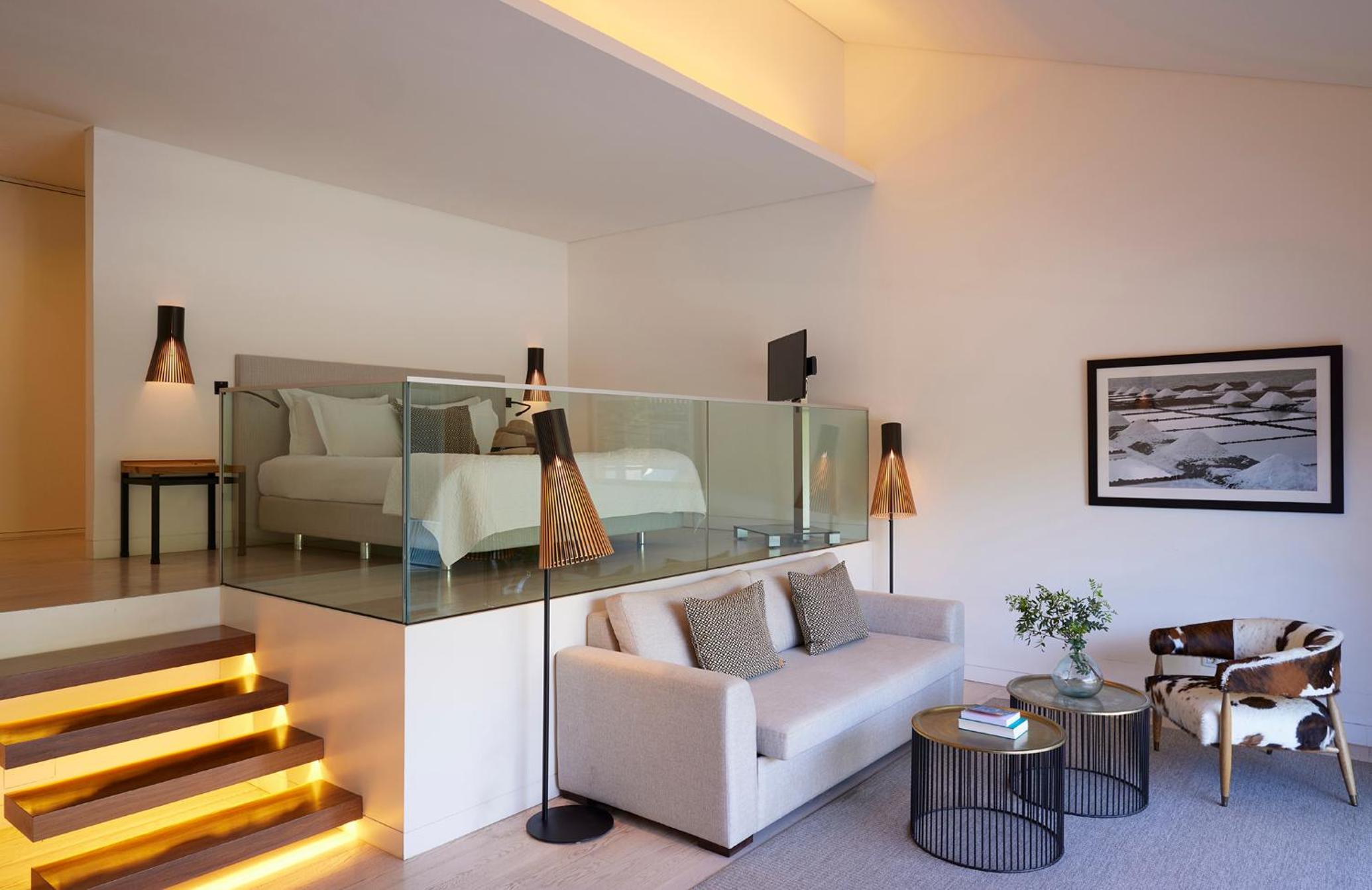 living room with a couch, chair, coffee table and stairs