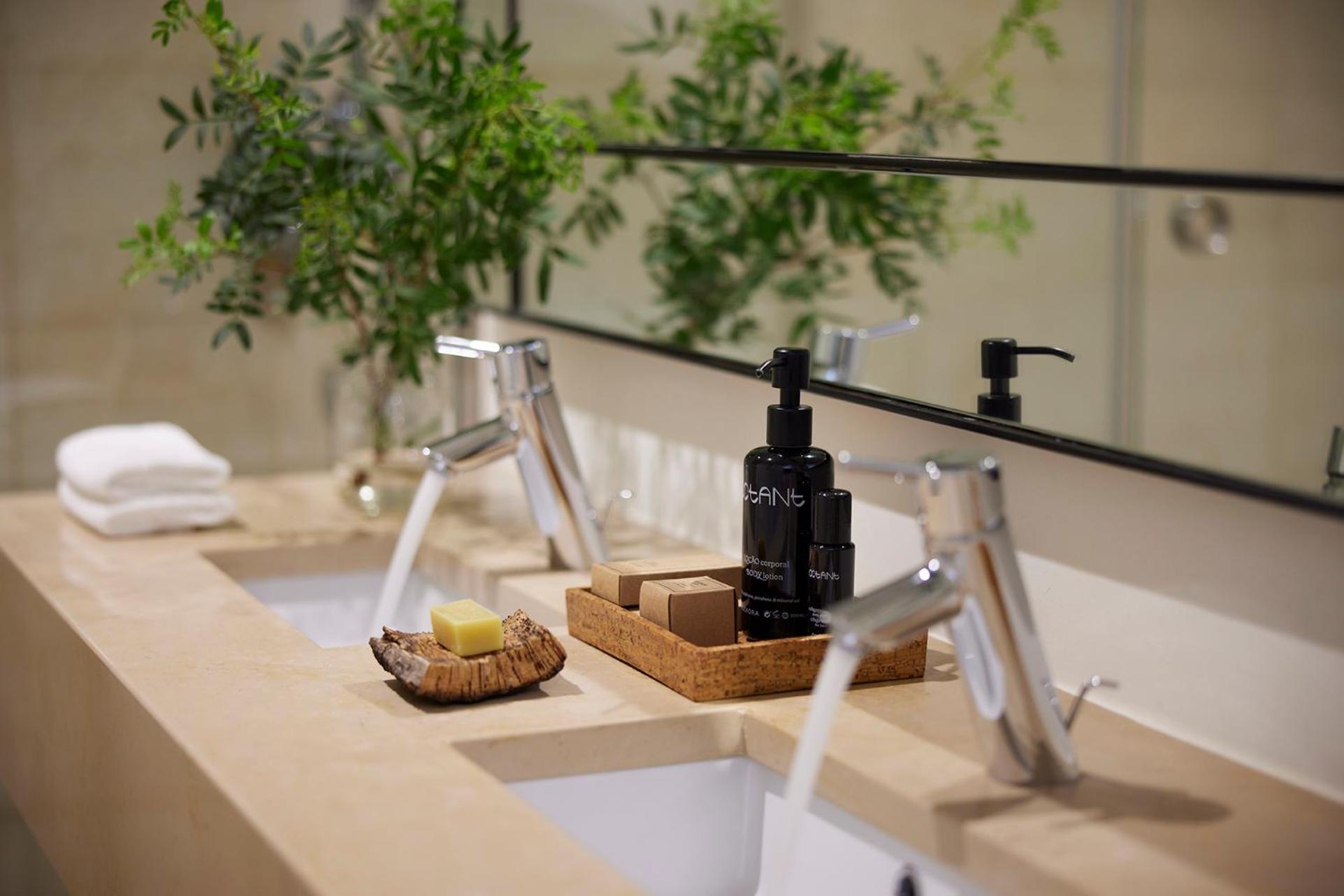 bathroom sink with soap and shampoos on it