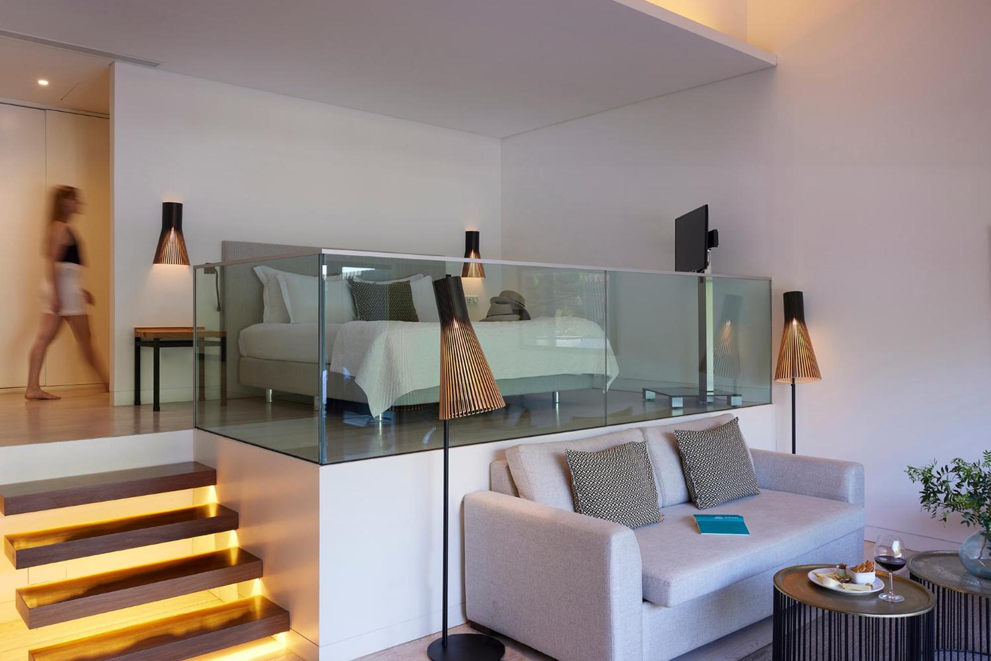 photo of a living room with a bed and stairs