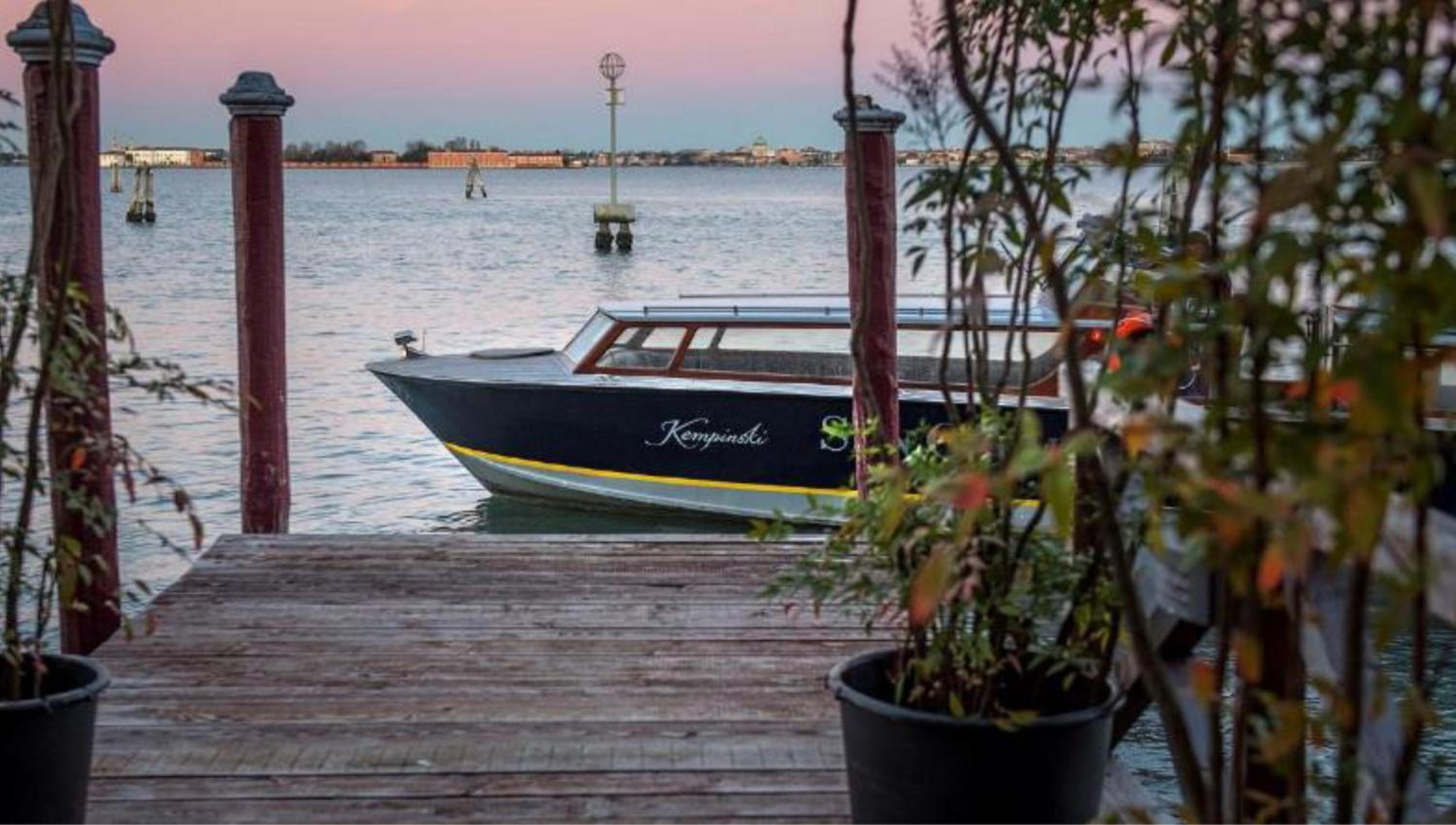 photo of a boat docked on the water at sunset