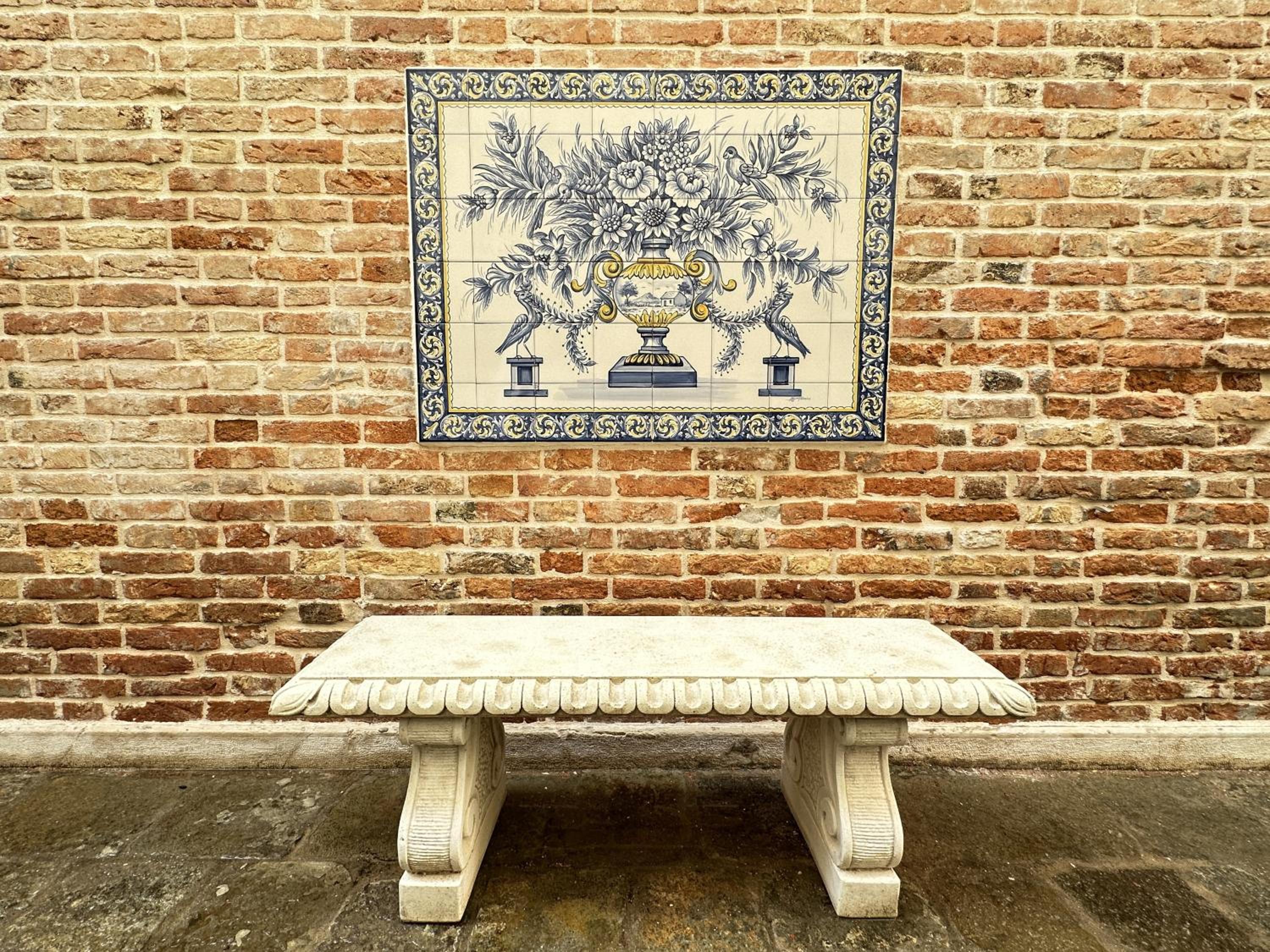 bench in front of a brick wall with a blue and white tile