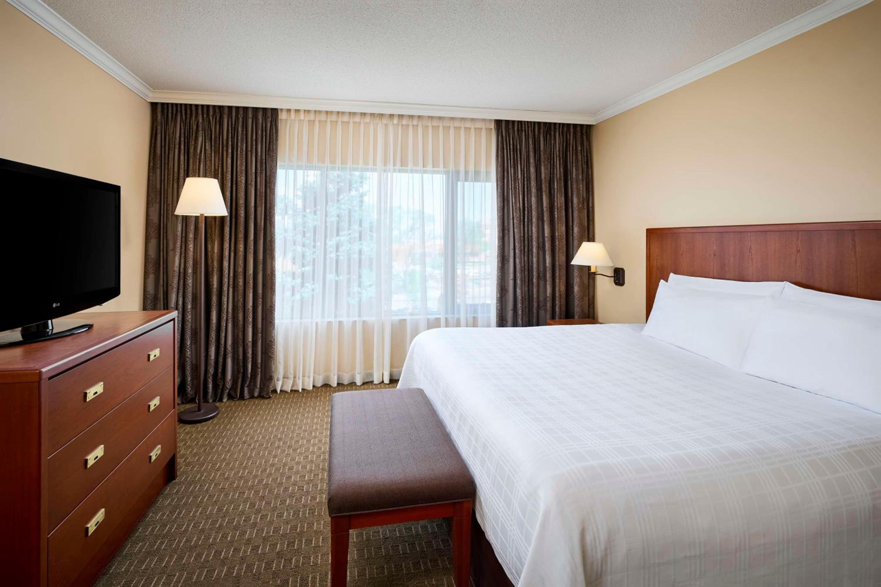 hotel room with a large bed and a flat screen tv