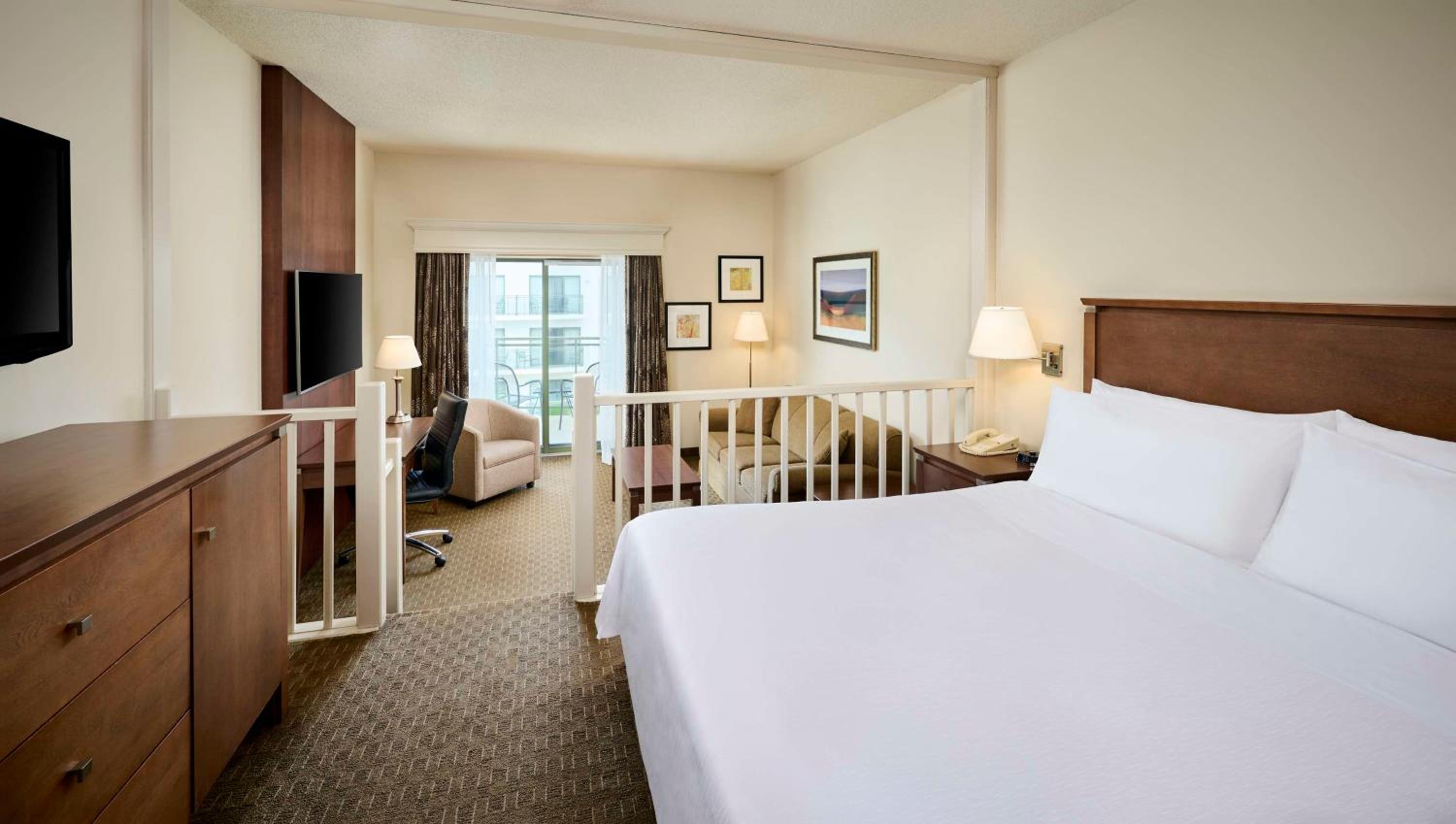 hotel room with a king size bed and balcony access