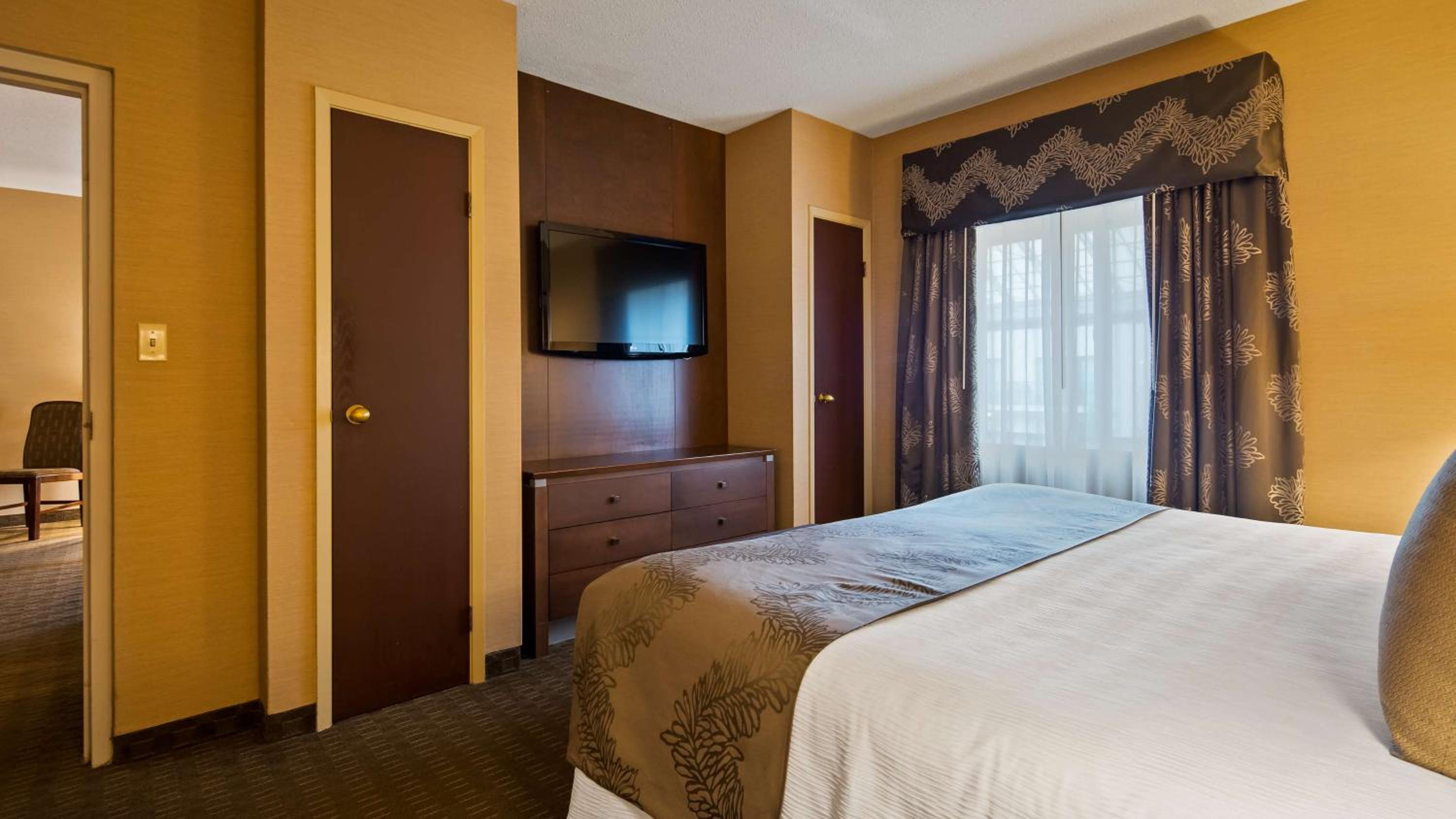 hotel room with a bed and a flat screen tv
