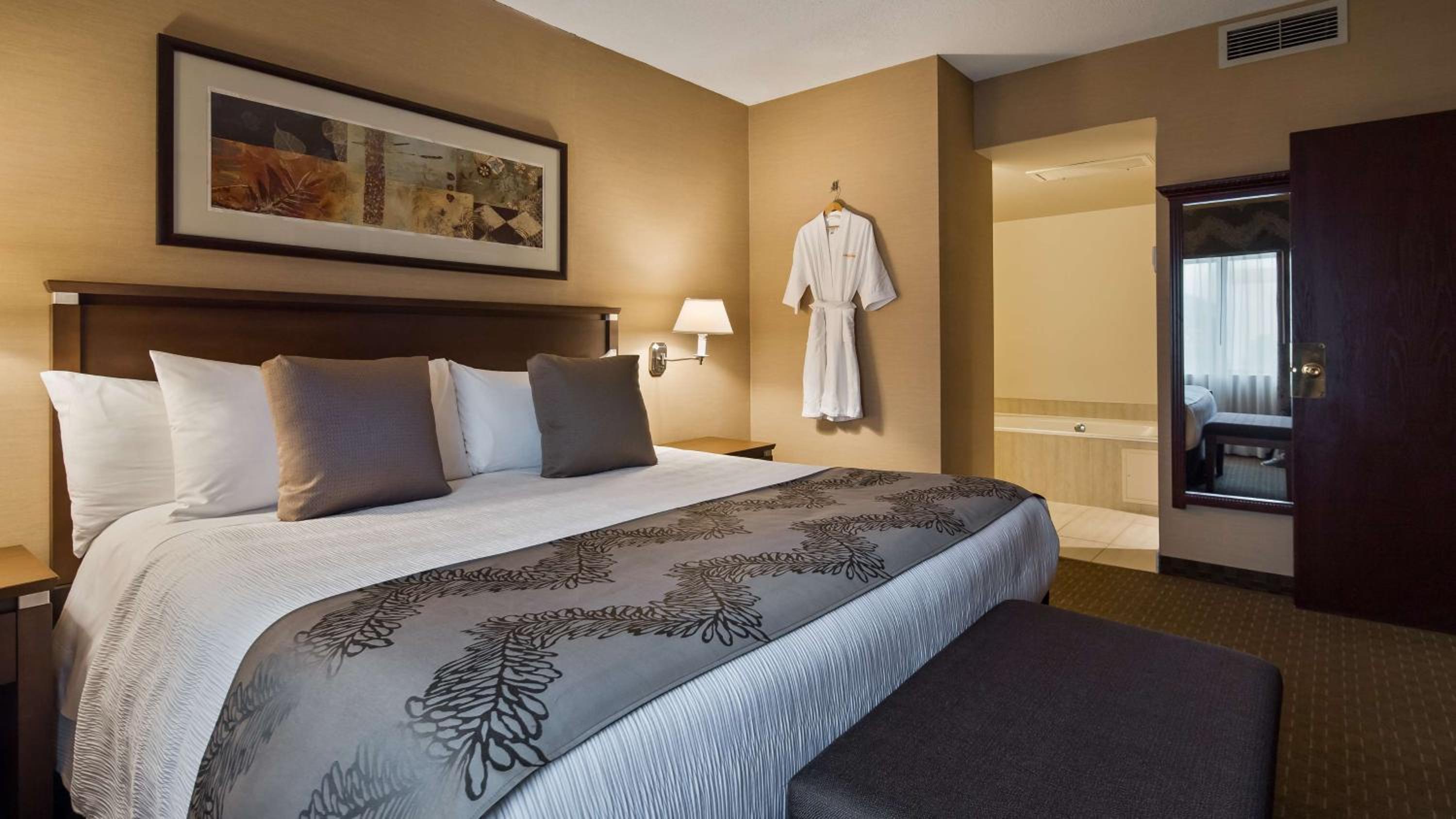 hotel room with a king size bed and bathtub