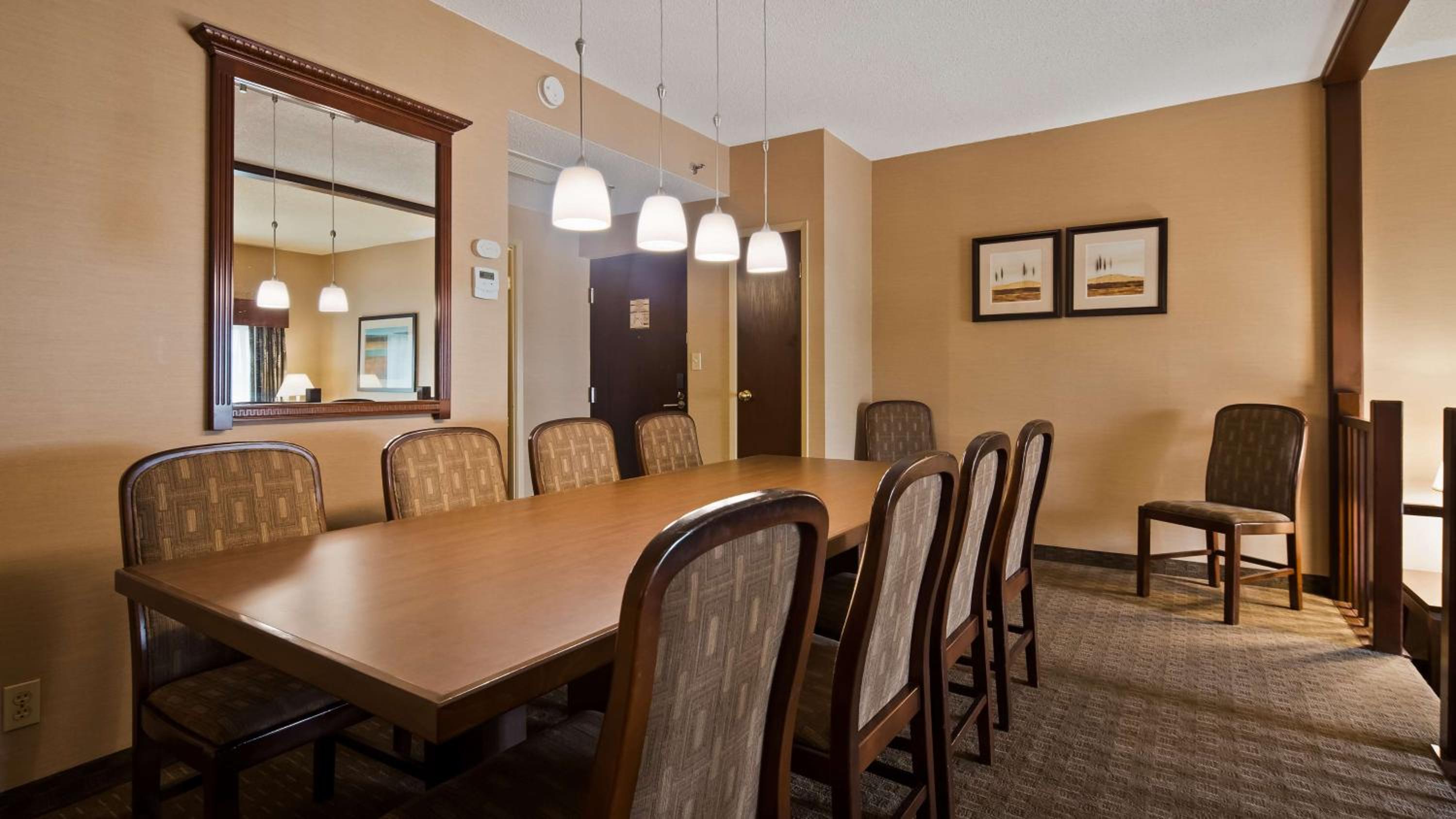 dining room table with chairs and a mirror on the wall