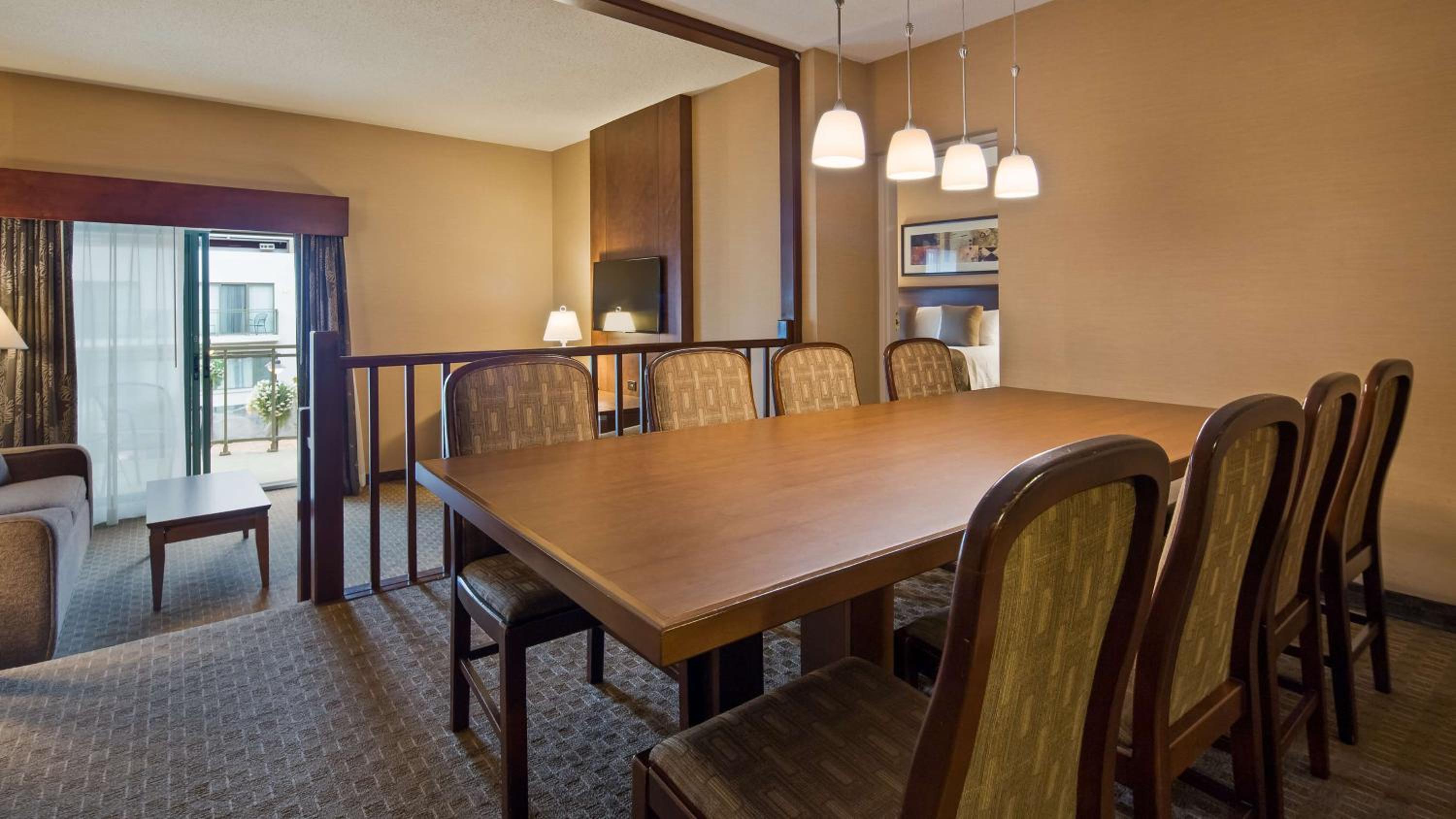dining room table with chairs and a flat screen tv