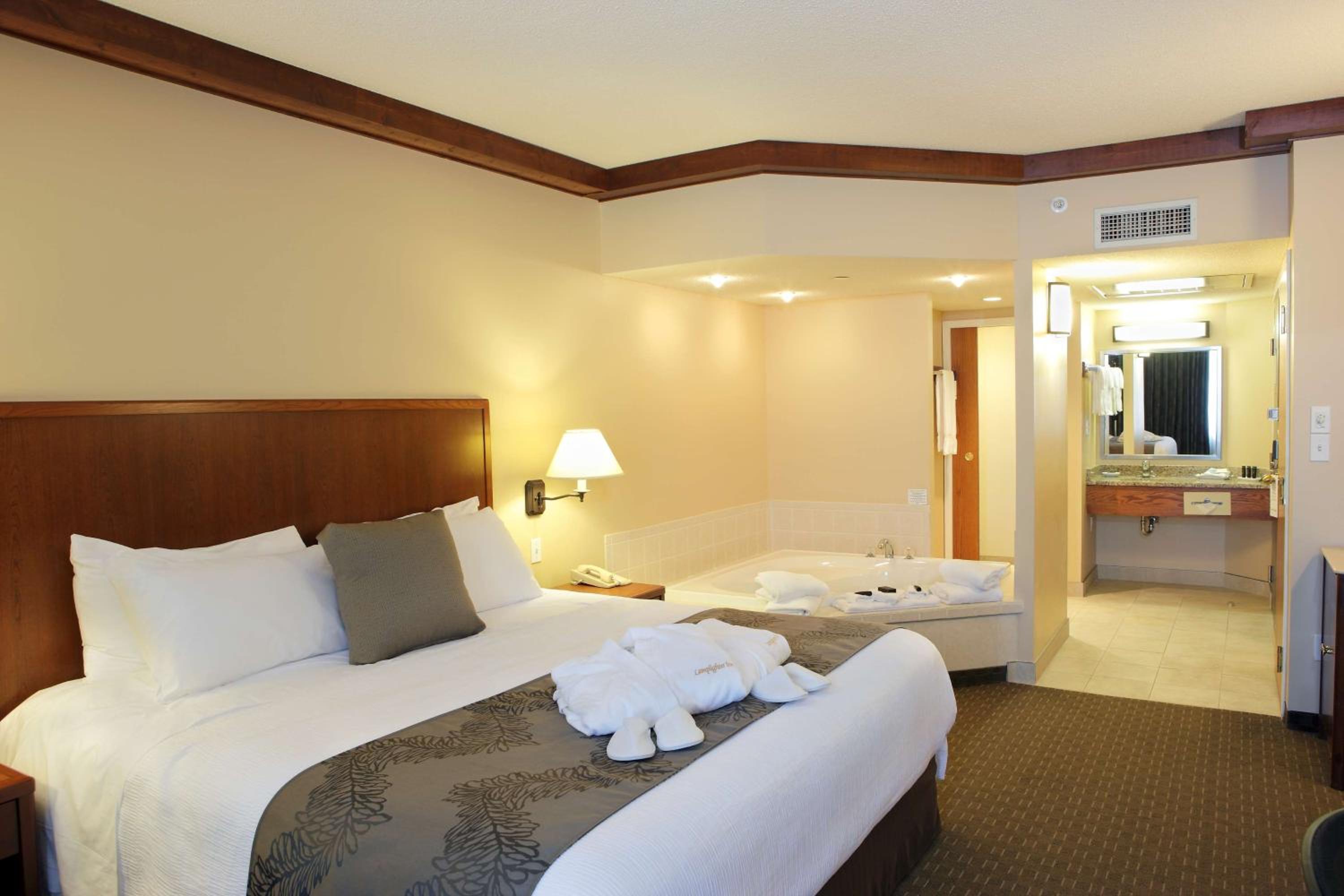hotel room with a jacuzzi tub in the corner