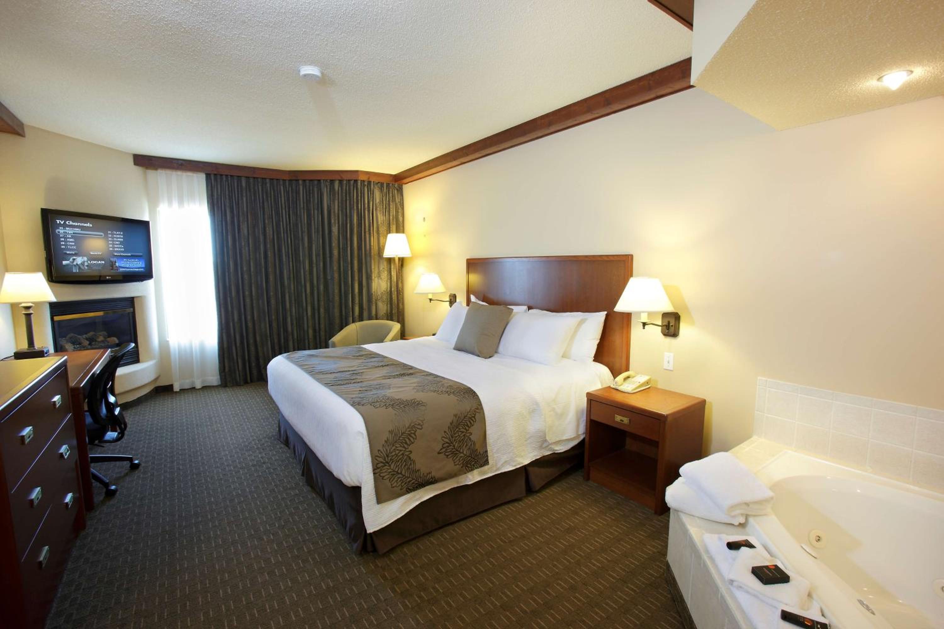 hotel room with a jacuzzi tub and television