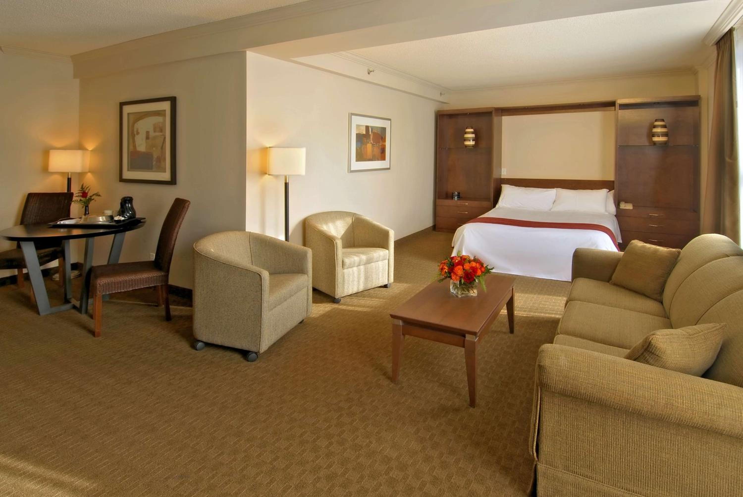 hotel room with a king size bed and sofas