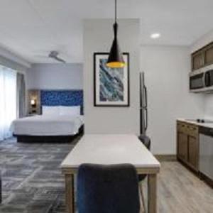 hotel room with a kitchen and living room in the background