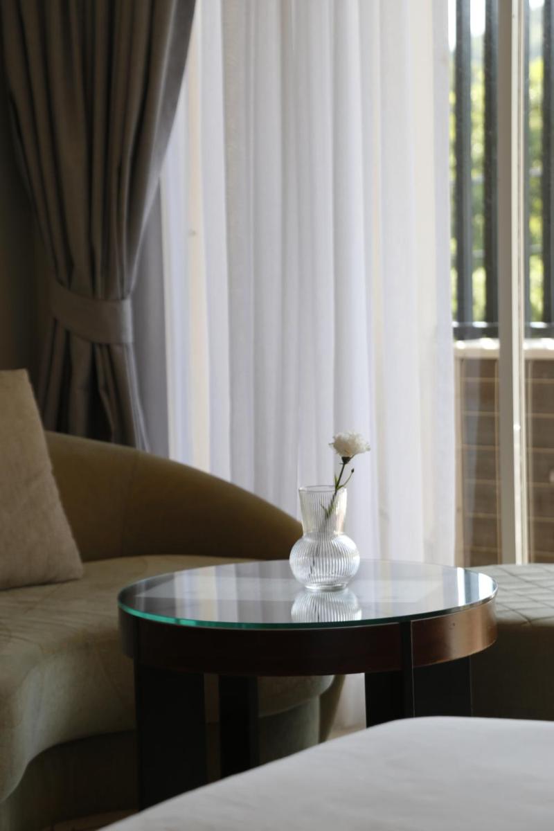 Deluxe King Room with Balcony - Photo 16