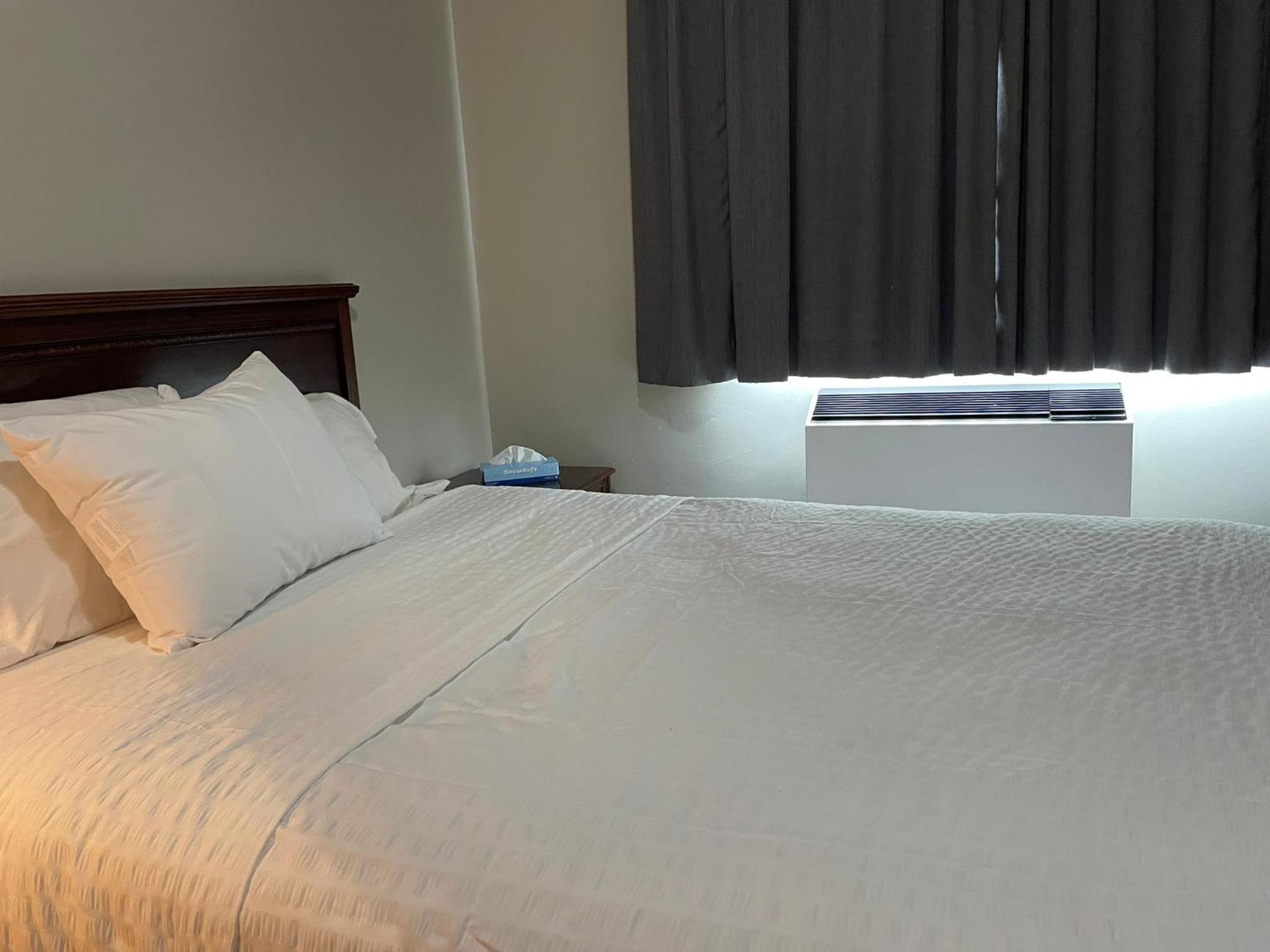 hotel room with a bed and a air conditioner