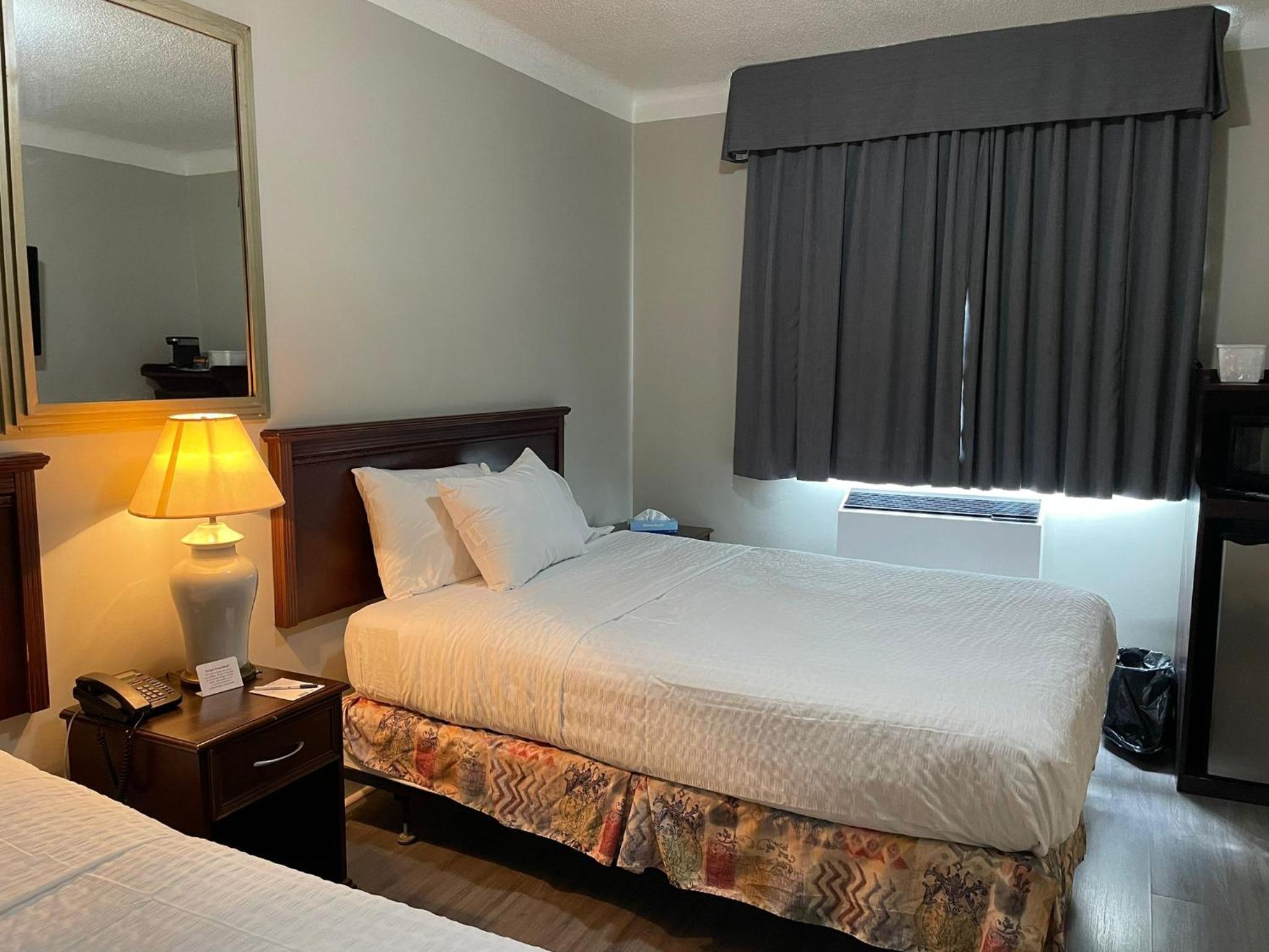 hotel room with two beds and a flat screen tv