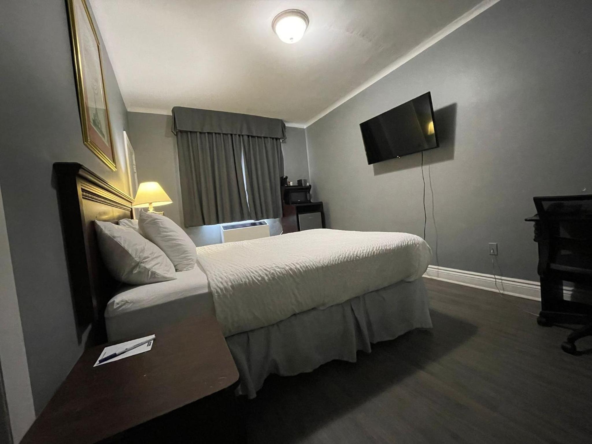 bedroom with a large bed and a flat screen tv