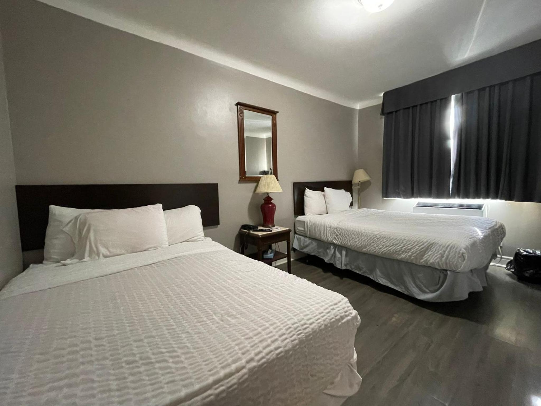 hotel room with two queen sized beds and a flat screen tv