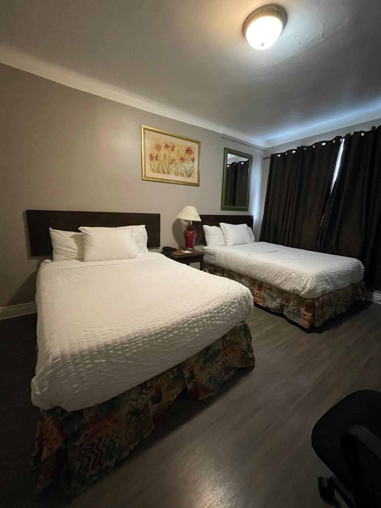 hotel room with two beds and a desk in the corner