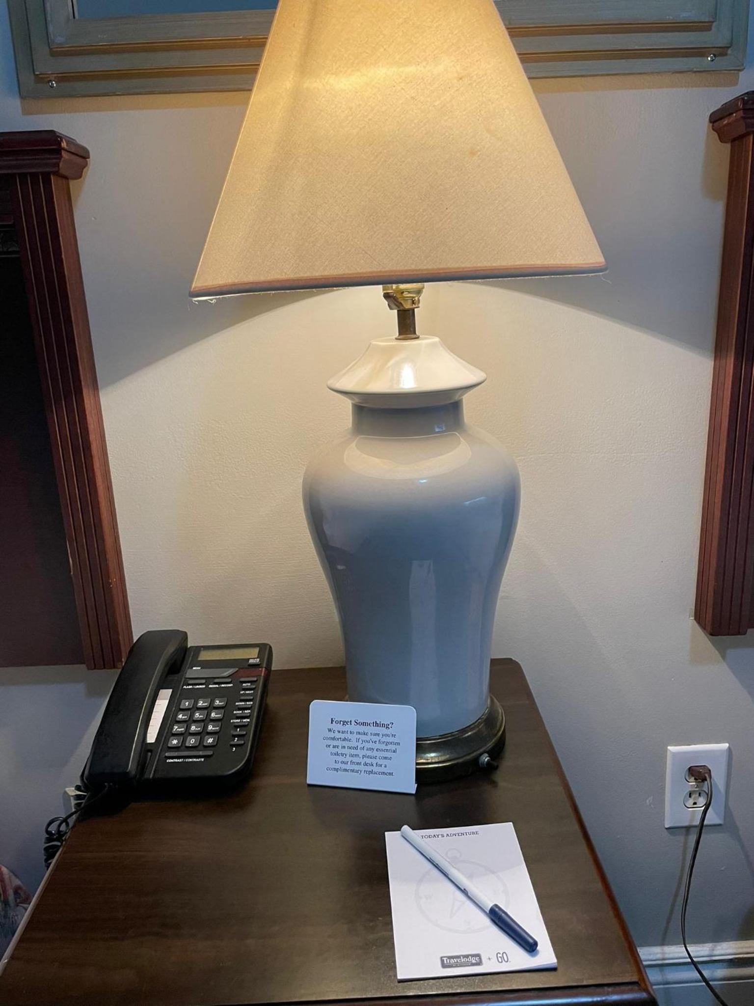 table with a lamp, telephone, and notepad