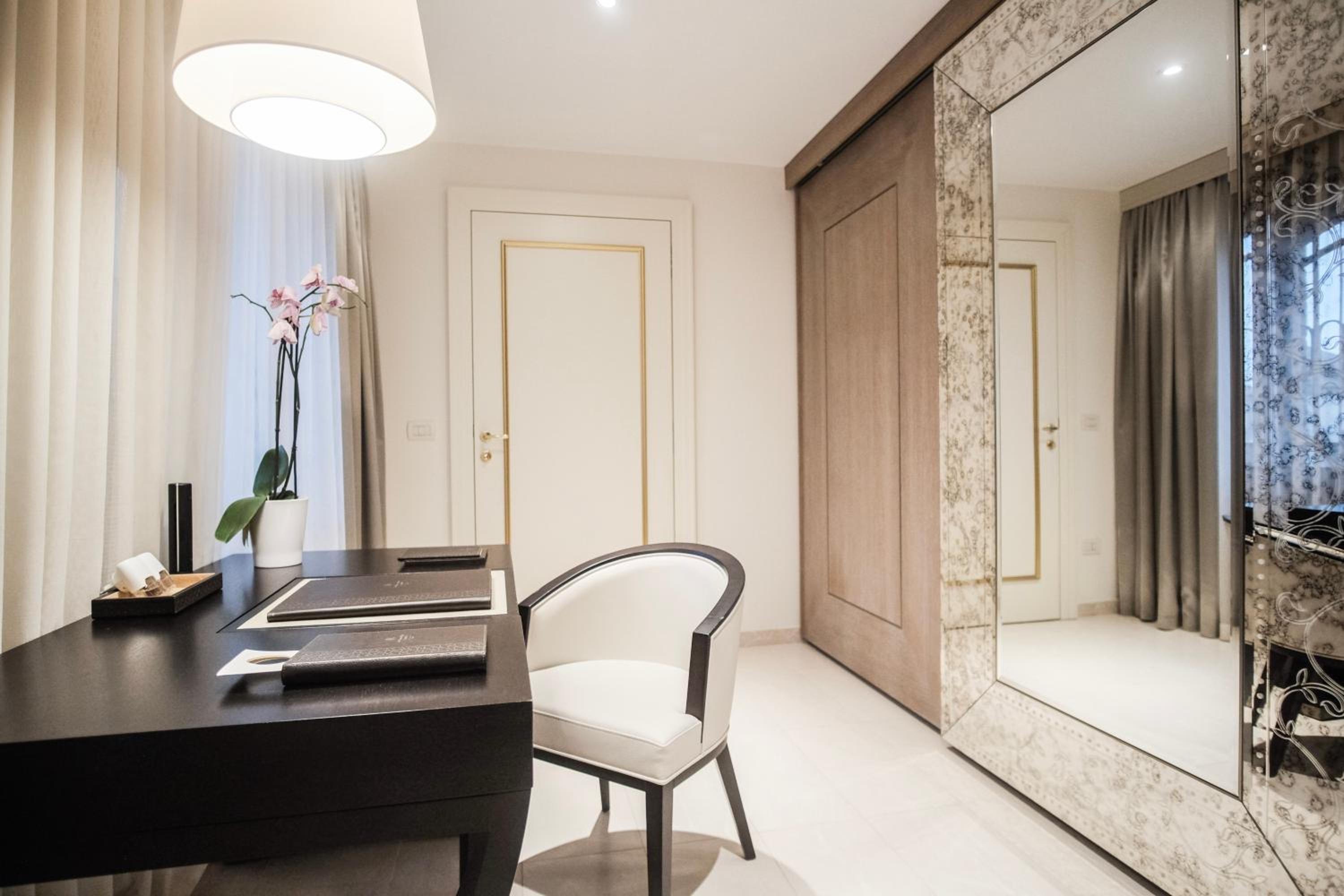 mirror and a desk with a chair in front of it