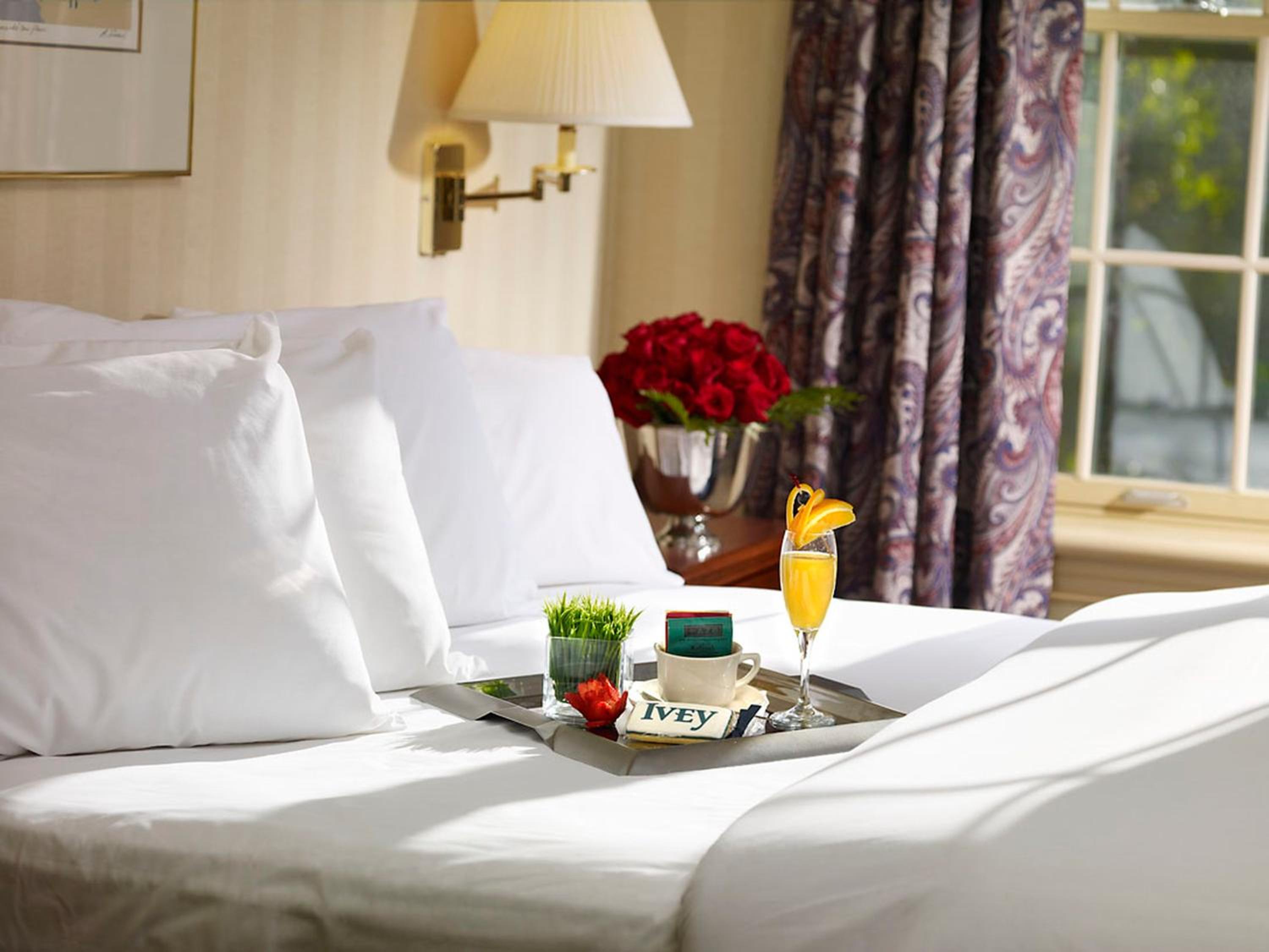 bed with a tray of food and drinks on it
