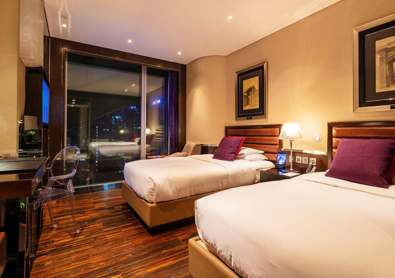 hotel room with two beds and a view of the city
