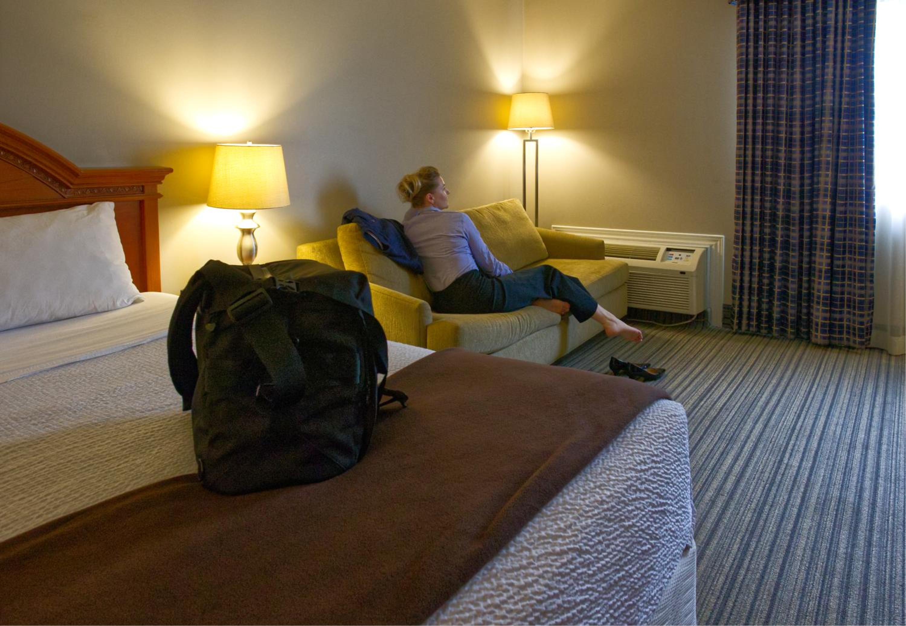 woman lounging on a couch in a hotel room