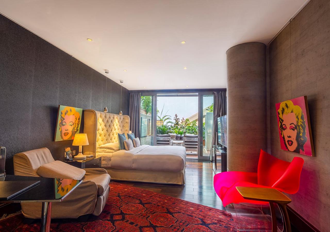 room with two beds and a red chair in it