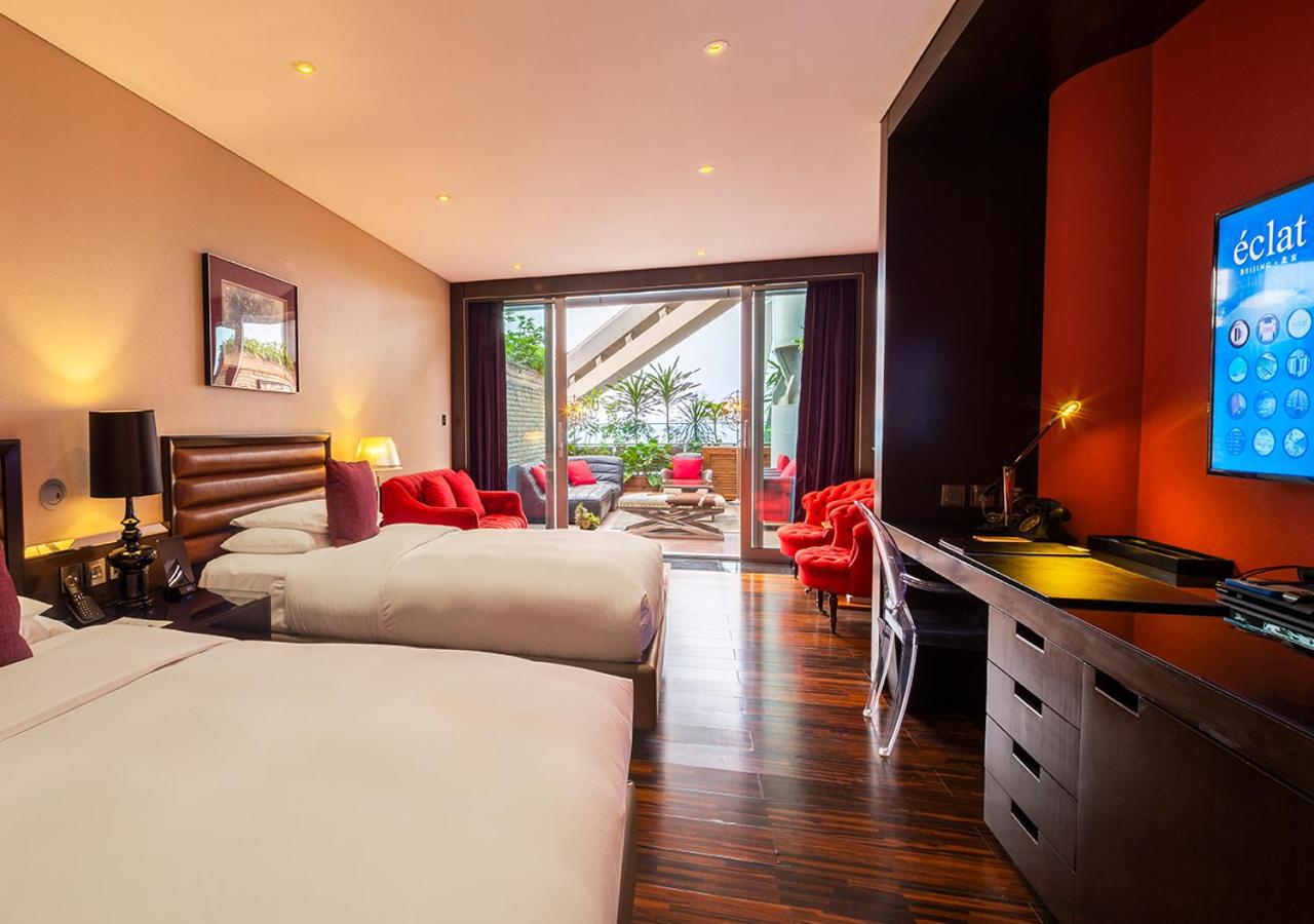 hotel room with two beds and a flat screen tv