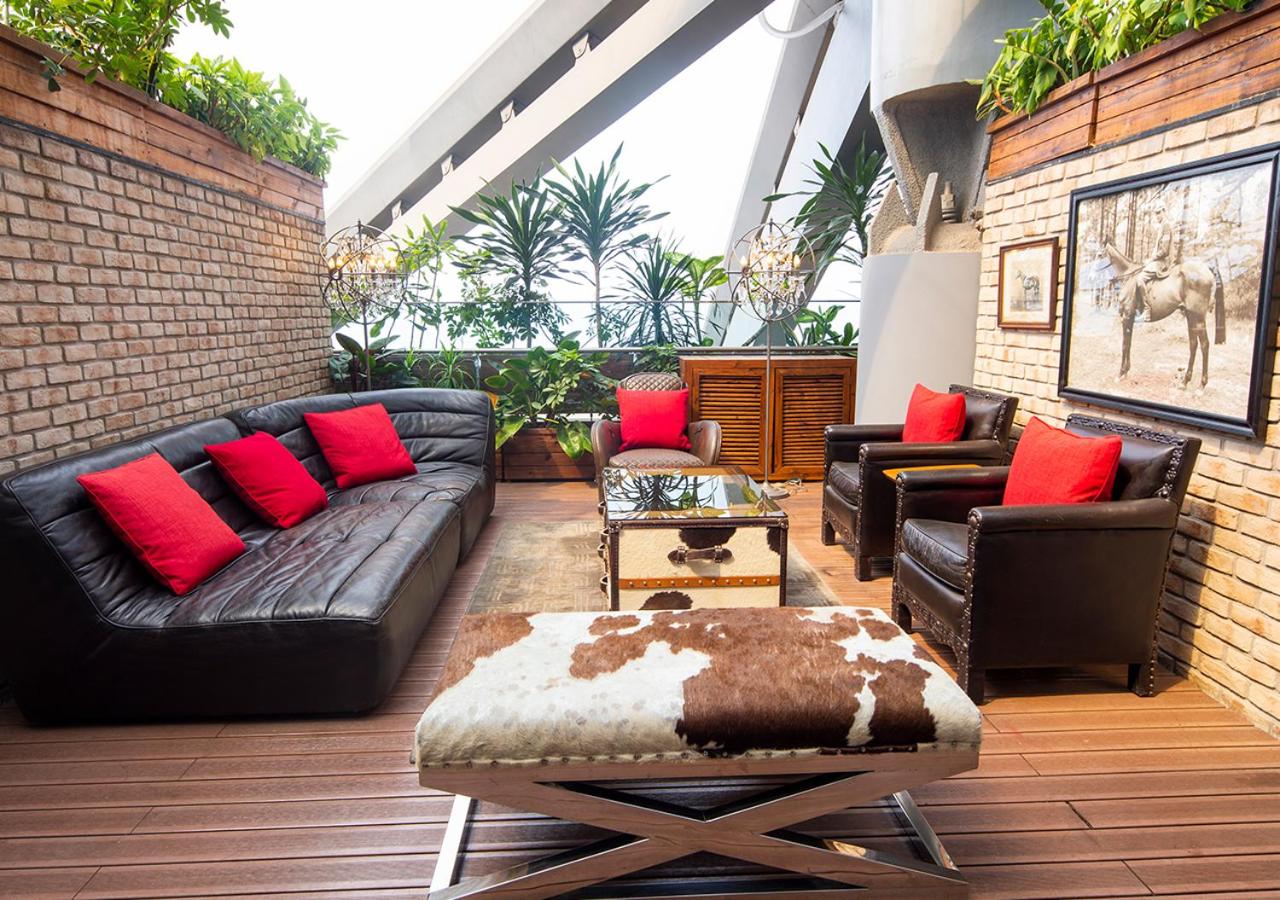 living room with leather couches and a cowhide ottoman