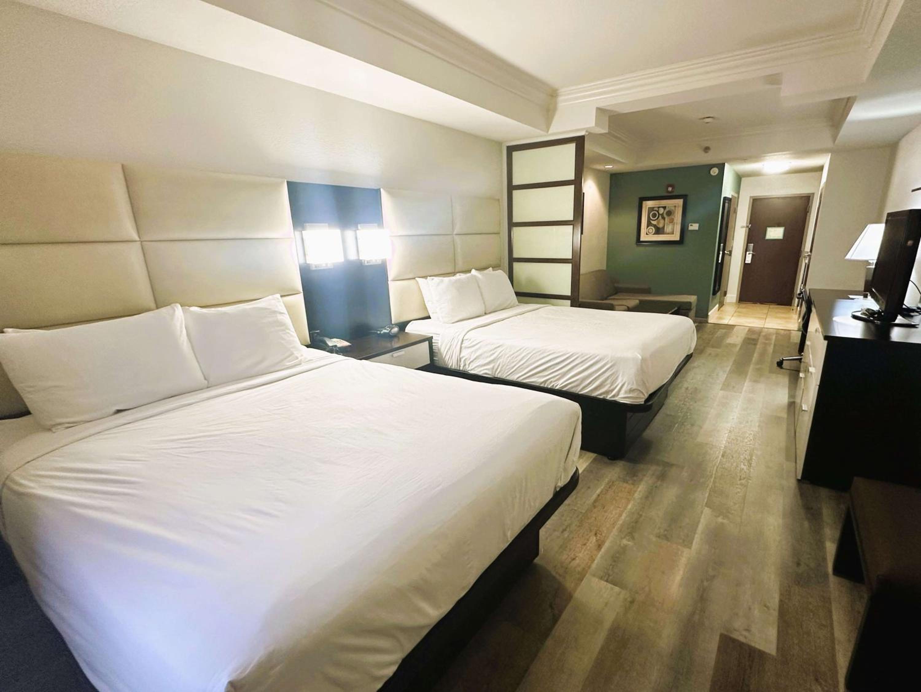 Queen Suite with Two Queen Beds and Sofa Bed - Photo 1