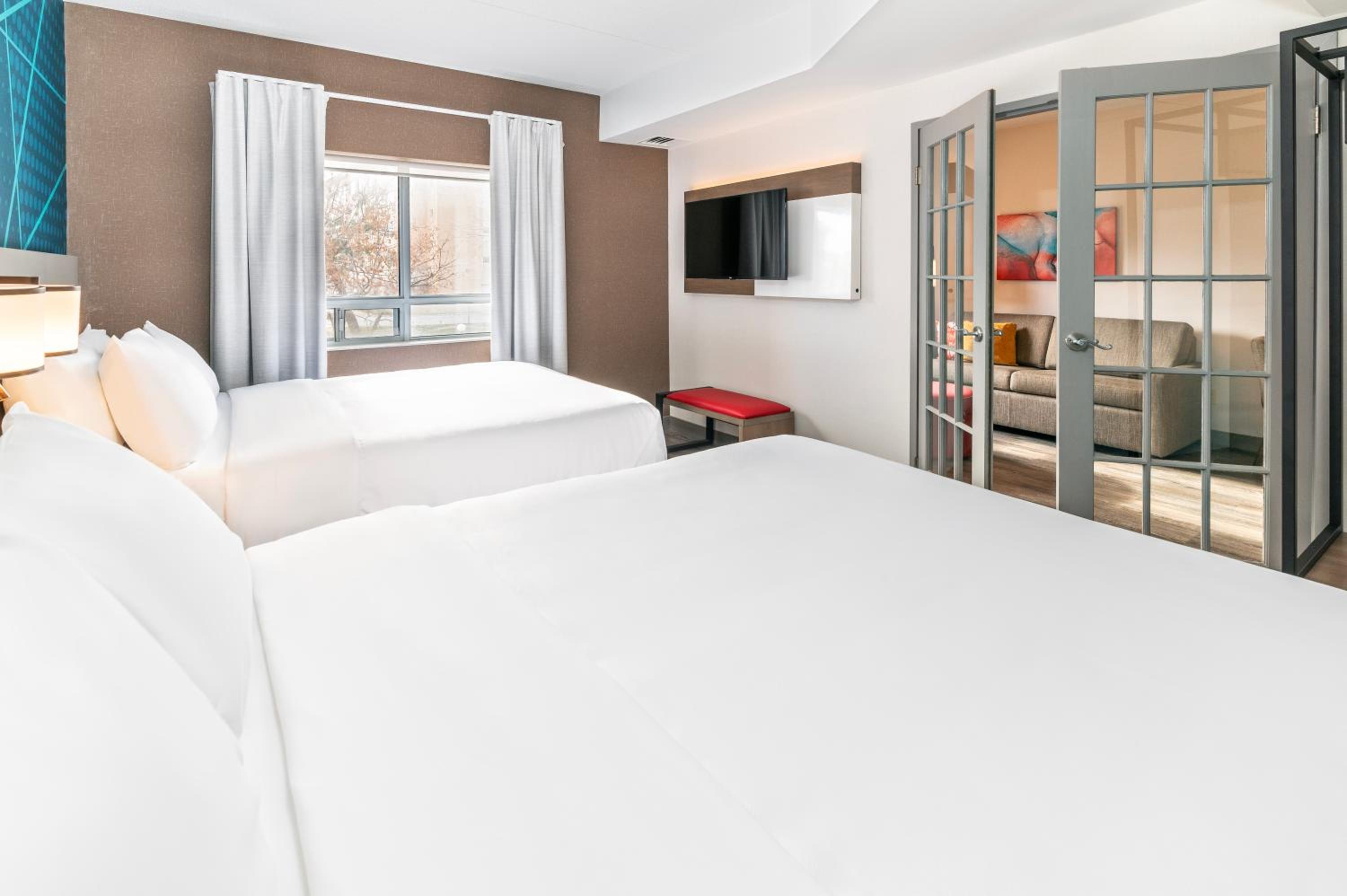 hotel room with two beds and a flat screen tv