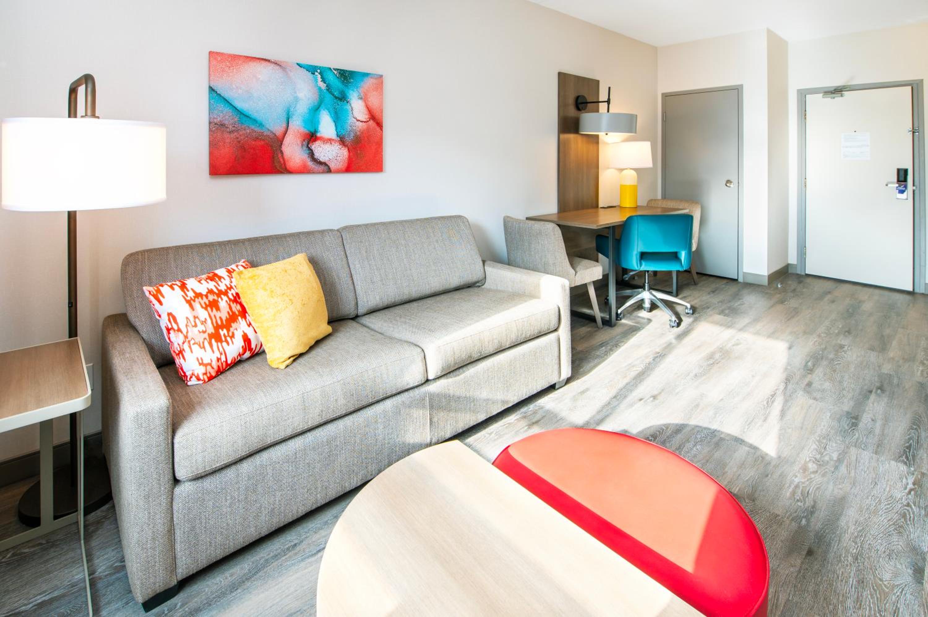 living room with a couch, coffee table, and desk