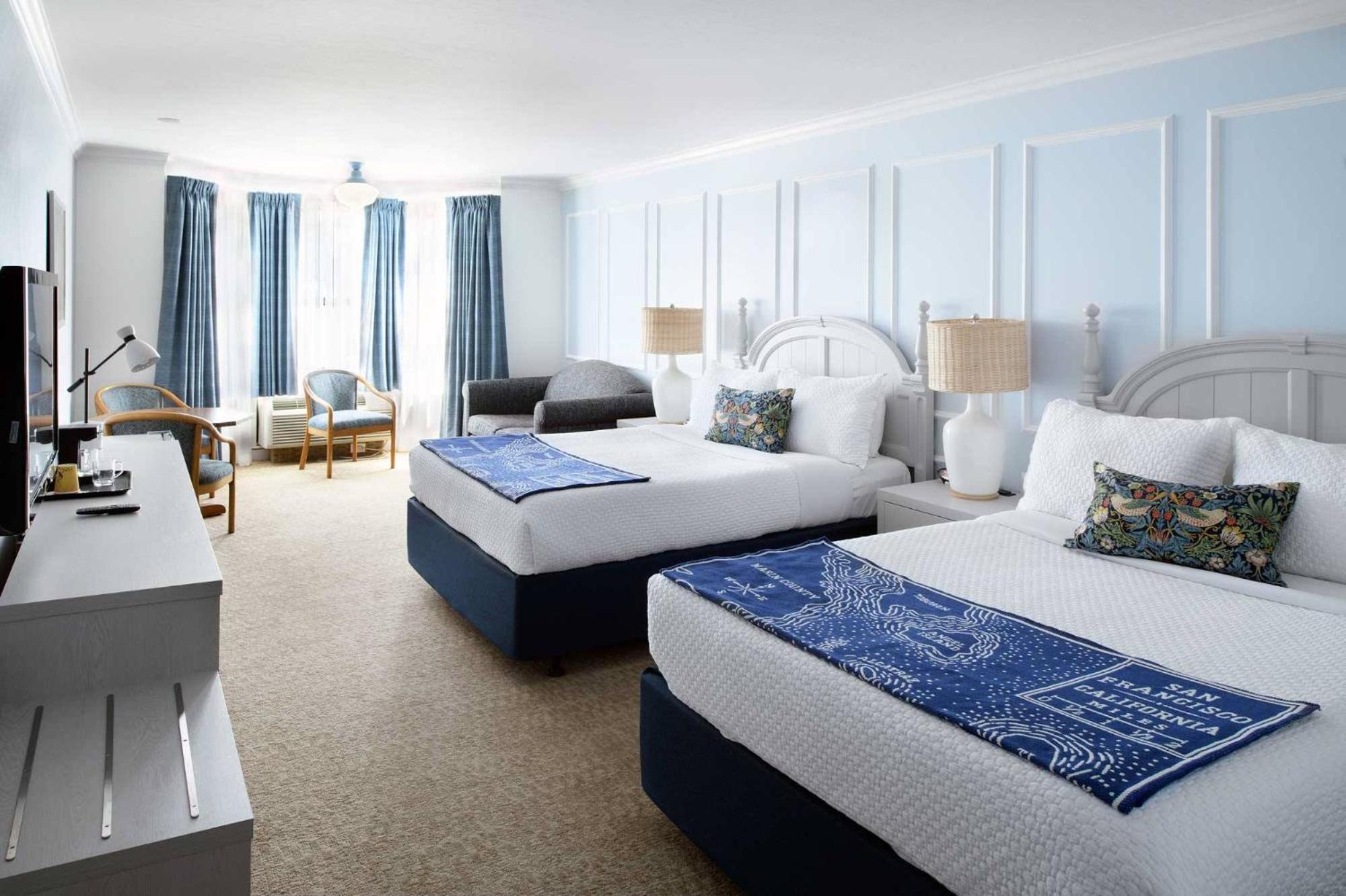 Two Queen Beds With A Couch