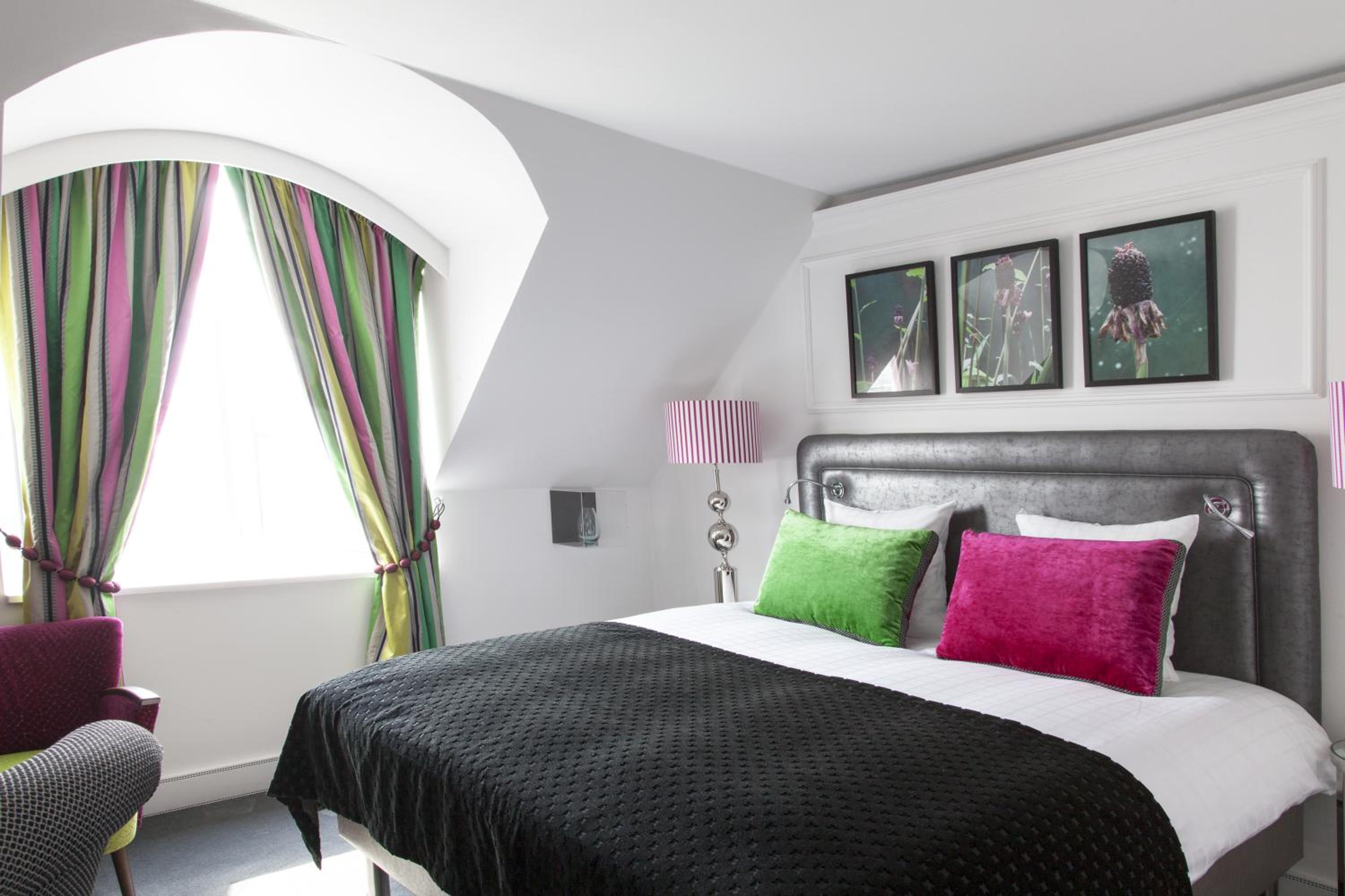 Stylish comfort awaits in this vibrant hotel room.